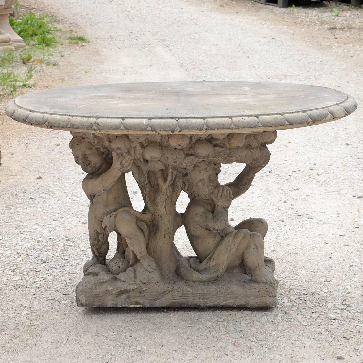 Oval shaped garden table with children under the surface. The foot depicts an apple tree. This table is available in various colors including antique grey, antique white, sandstone and terracotta.