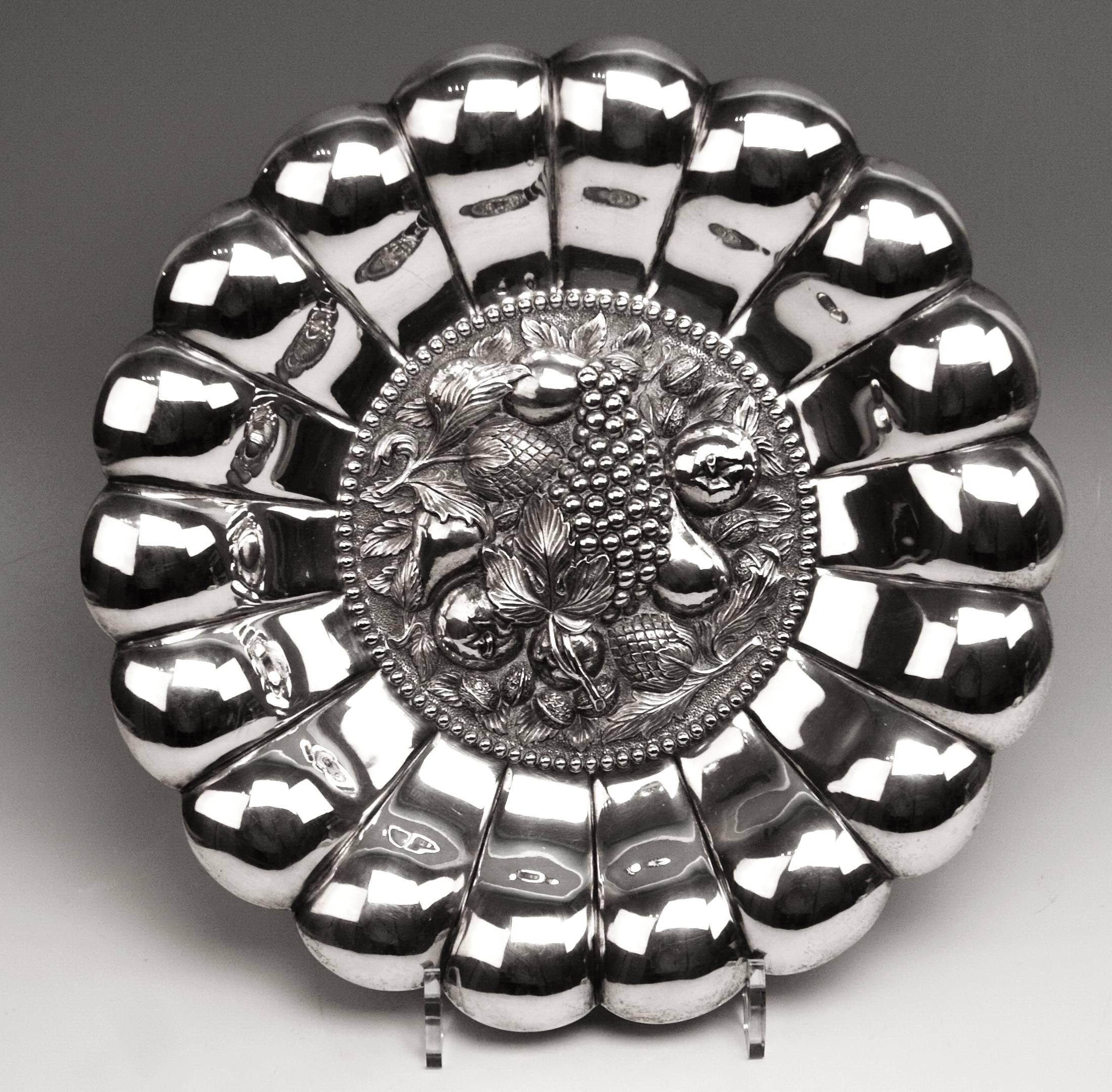 Stunning nicest silver plate with sculptured decorations in middle area
Hallmarked (Viennese silver) 
Manufactured, circa 1890

It is an outstanding quite large silver plate of finest manufacturing quality:
Referring to style, it is made in