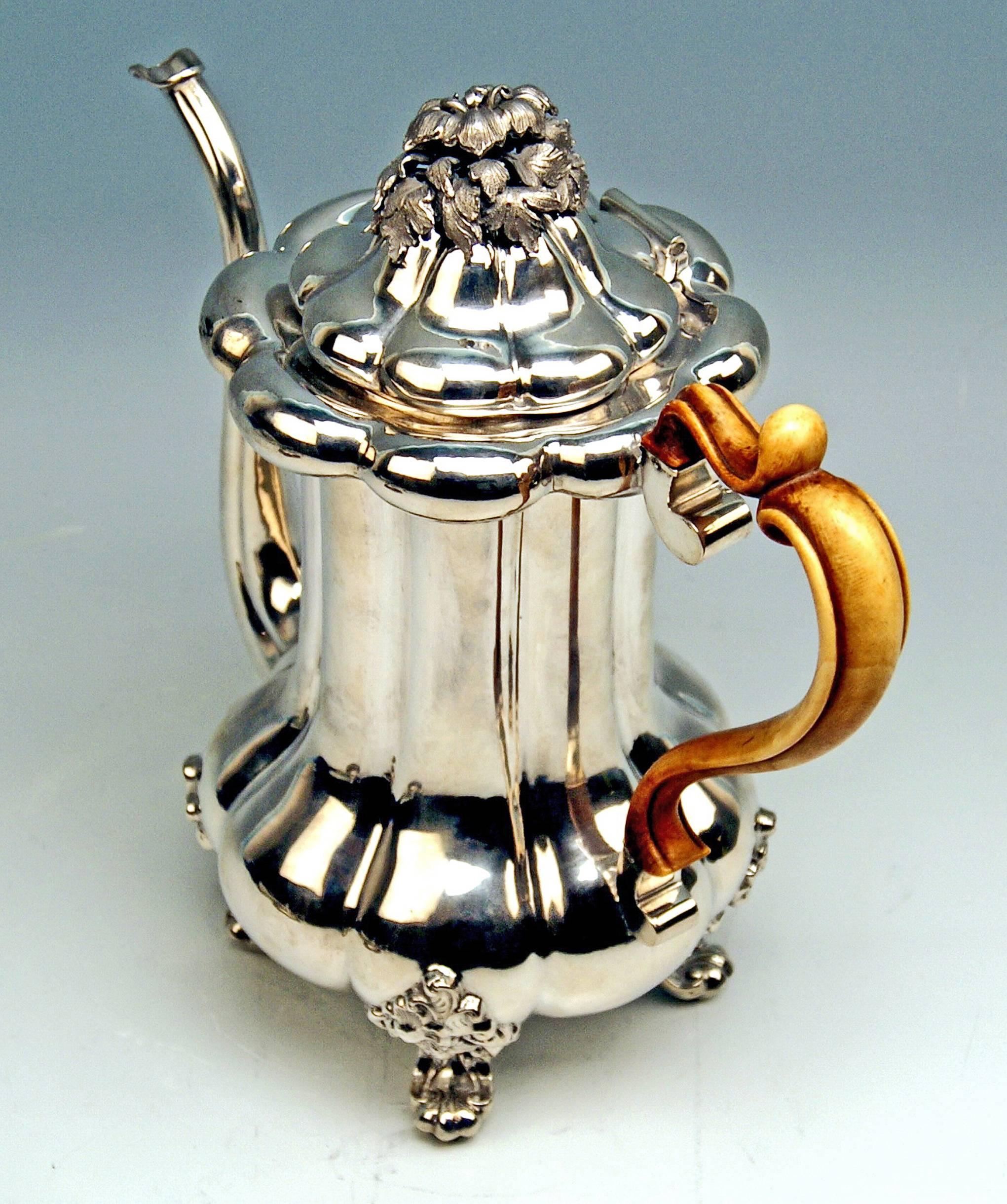 Austrian Late Biedermeier Silver 812.5 tall coffee pot
Dated 1853 

Finest manufacturing quality: 
The pot based on Rocaille feet is pear-shaped in area below whereas it is of cylindric form type above = very interesting appearance ! The domed