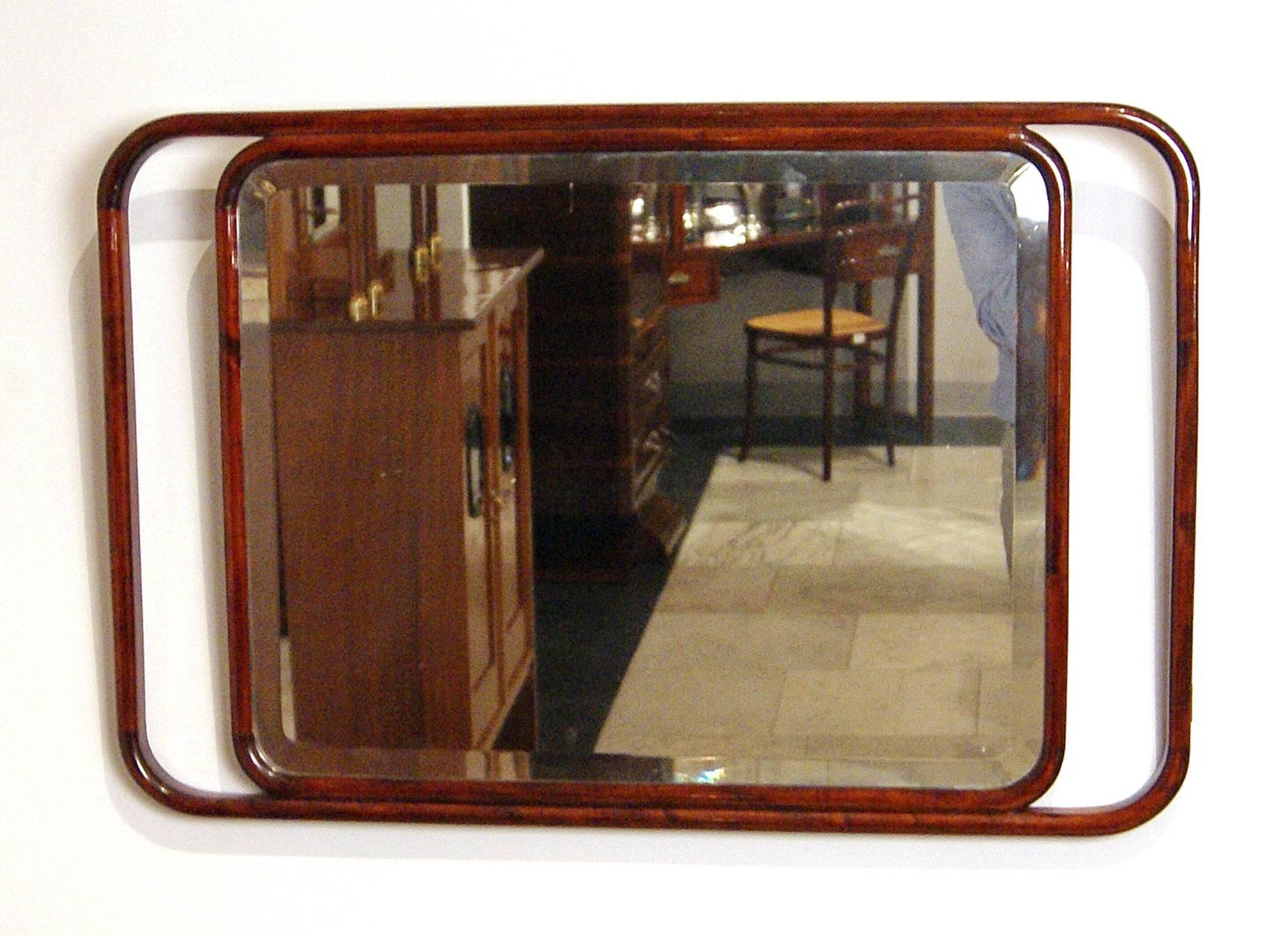 Art Nouveau wall mounted mirror
made circa 1905.

Manufactory:
Jacob & Josef Kohn / Vienna 
Model 1148 

Beech wood (bentwood furniture), dark mahogany stained, refurbished by hand. 
Rectangular elegant mirror having duplicate edge and