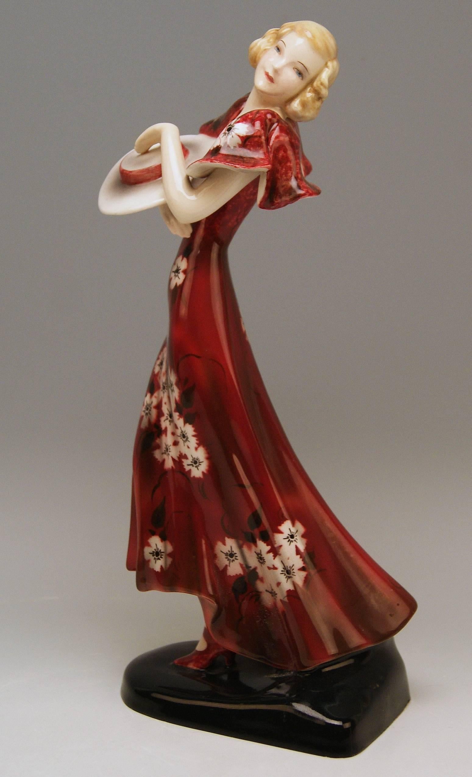 Goldscheider Vienna stunning Art Deco figurine: Lady with hat clad in red dress

Designed by Stefan (= Stephen) Dakon (1904-1992)
modelled circa 1934 made circa 1935 
model number 6940 / 266 / 14

Hallmarked:
Goldscheider WIEN (= VIENNA) stamp