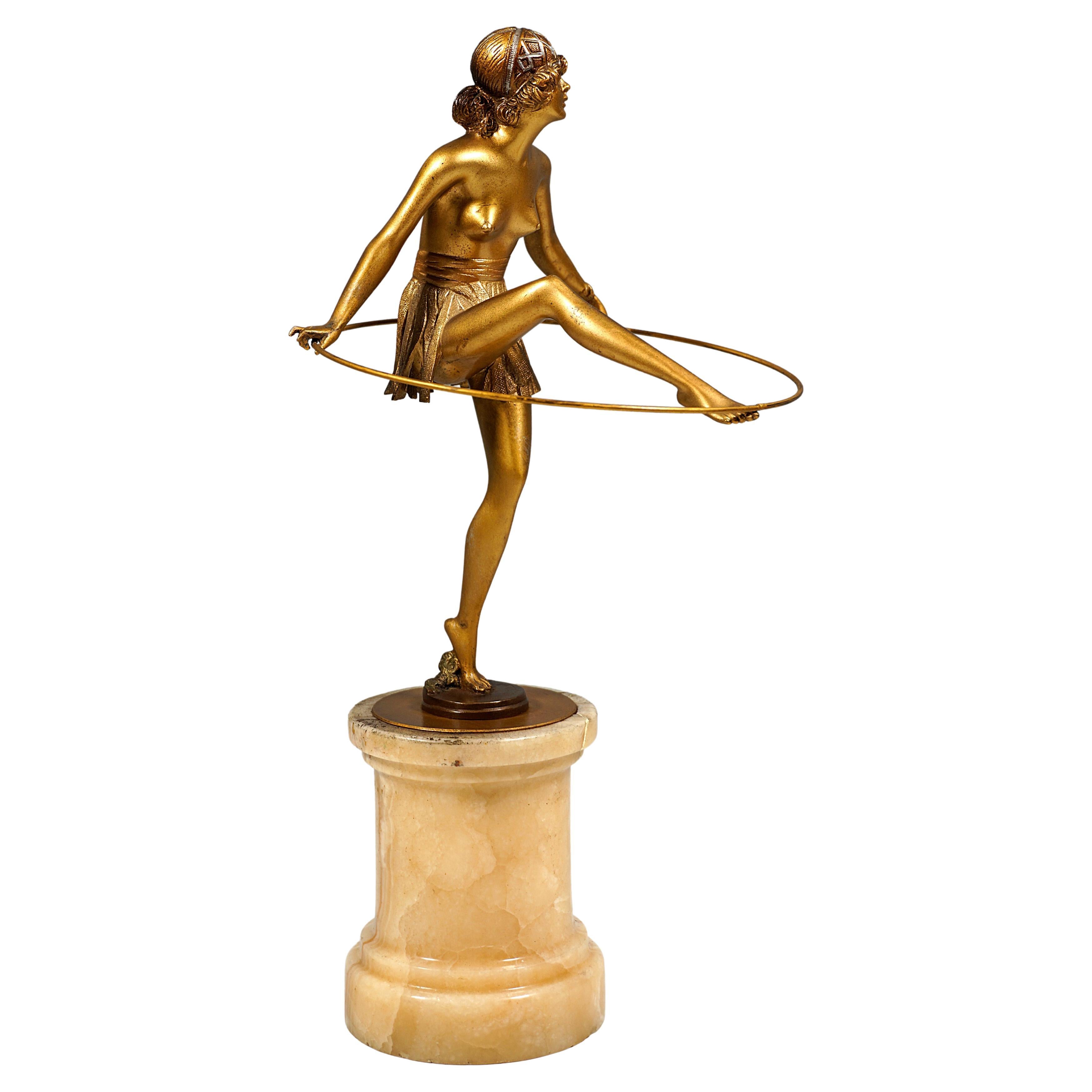 Interesting Vienna bronze figurine: Semi-nude lady holding a hoop
 
It is a finest figurine. The bare-breasted lady stands on round flat bronze base which is attached to column made of brownish-white marble. The female nude holds a hoop in both