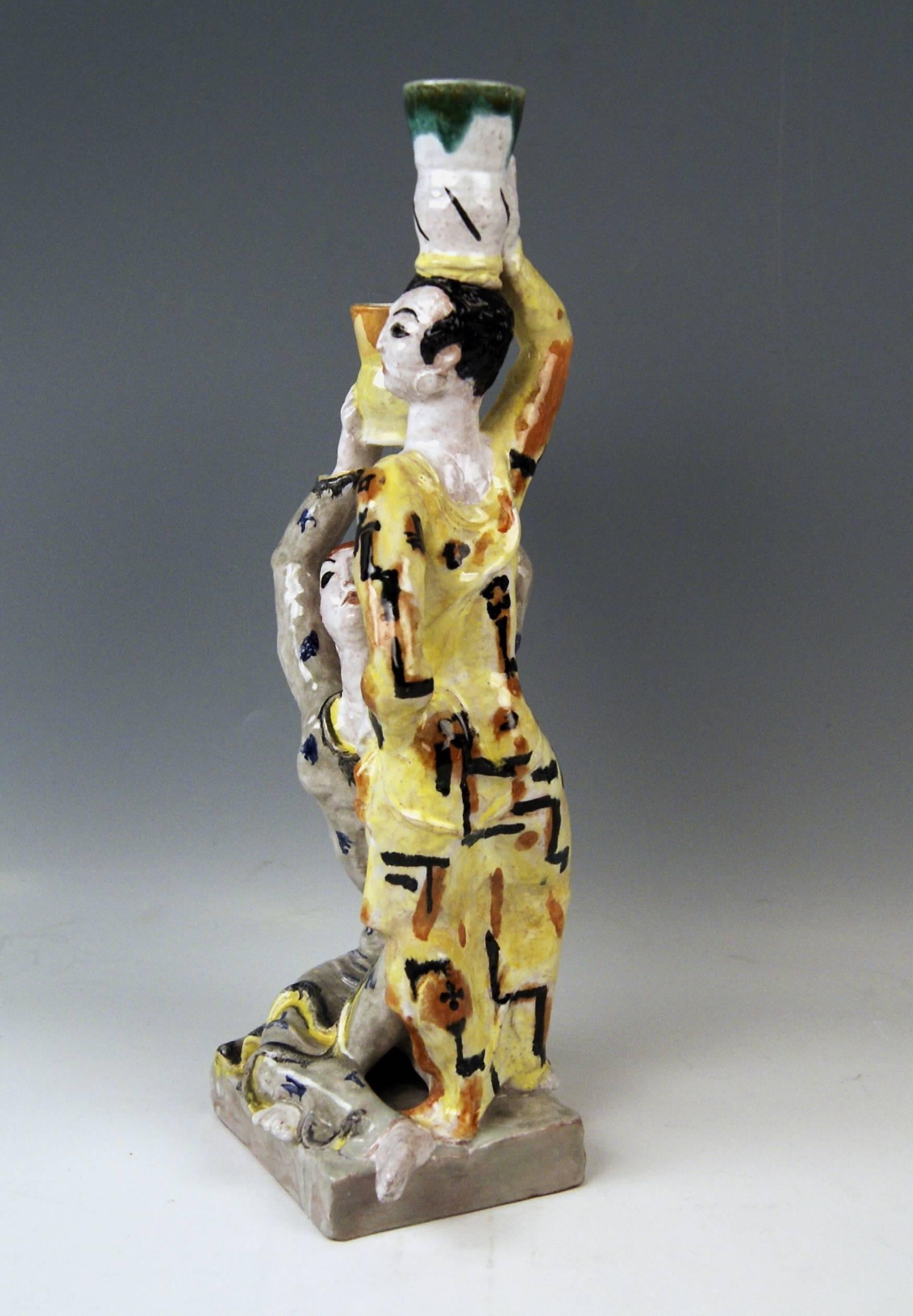 Two Figurines Wearing Vessels  (Expressionism)  made by WIENER WERKSTAETTE   (= Vienna Workshop).

DESIGN: 
ERNA KOPRIVA  (born 1894 in Vienna – died 1984 there).
Born in Vienna as daughter of a medical doctor, Erna Kopriva has become pupil of