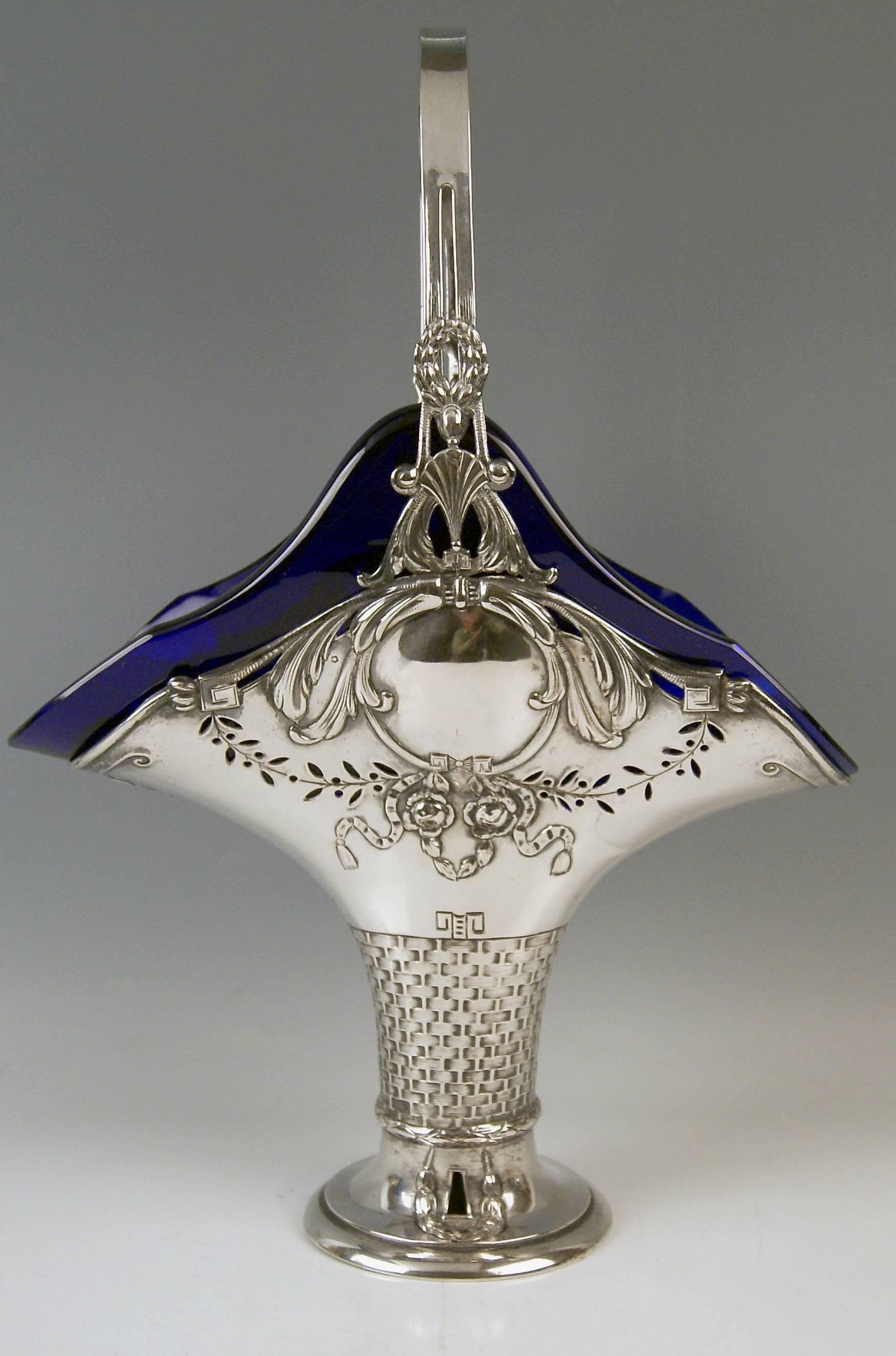 Silver huge basket with handle and cobalt blue glass liner.
Art Nouveau period  made circa 1900-1905.

Excellently made tall silver basket of finest quality.

The basket's surface is abundantly decorated with various ornaments, for example:
