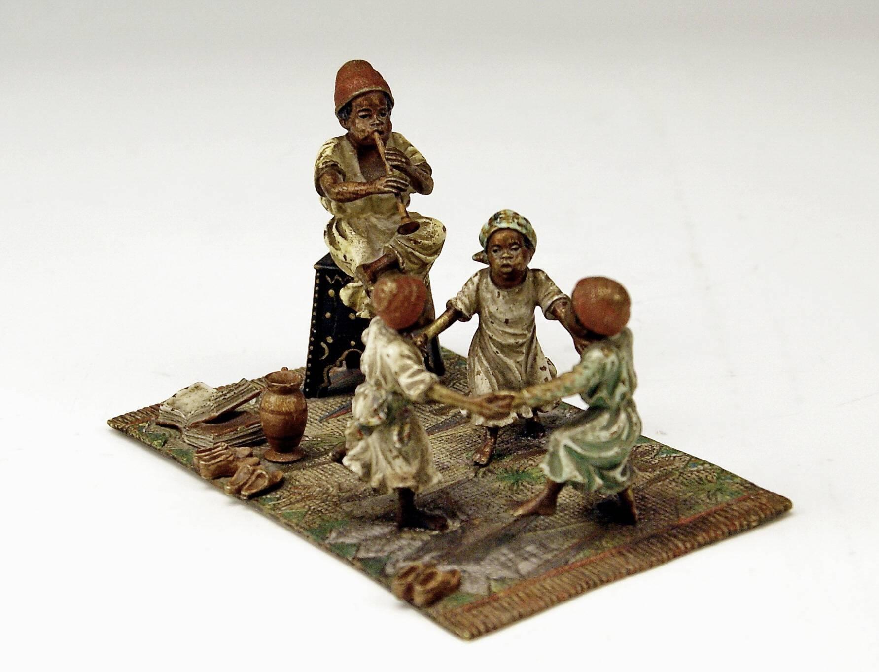 Gorgeous Vienna Bronze Figurine Group made by famous manufactory Bergman(n).
Made circa 1890 - 1900. 

Subject:
There is an ARAB MAN HAVING SAT DOWN ON ORIENTAL STOOL who plays a trumpet / THREE CHILDREN  are gladly busy with round dance     