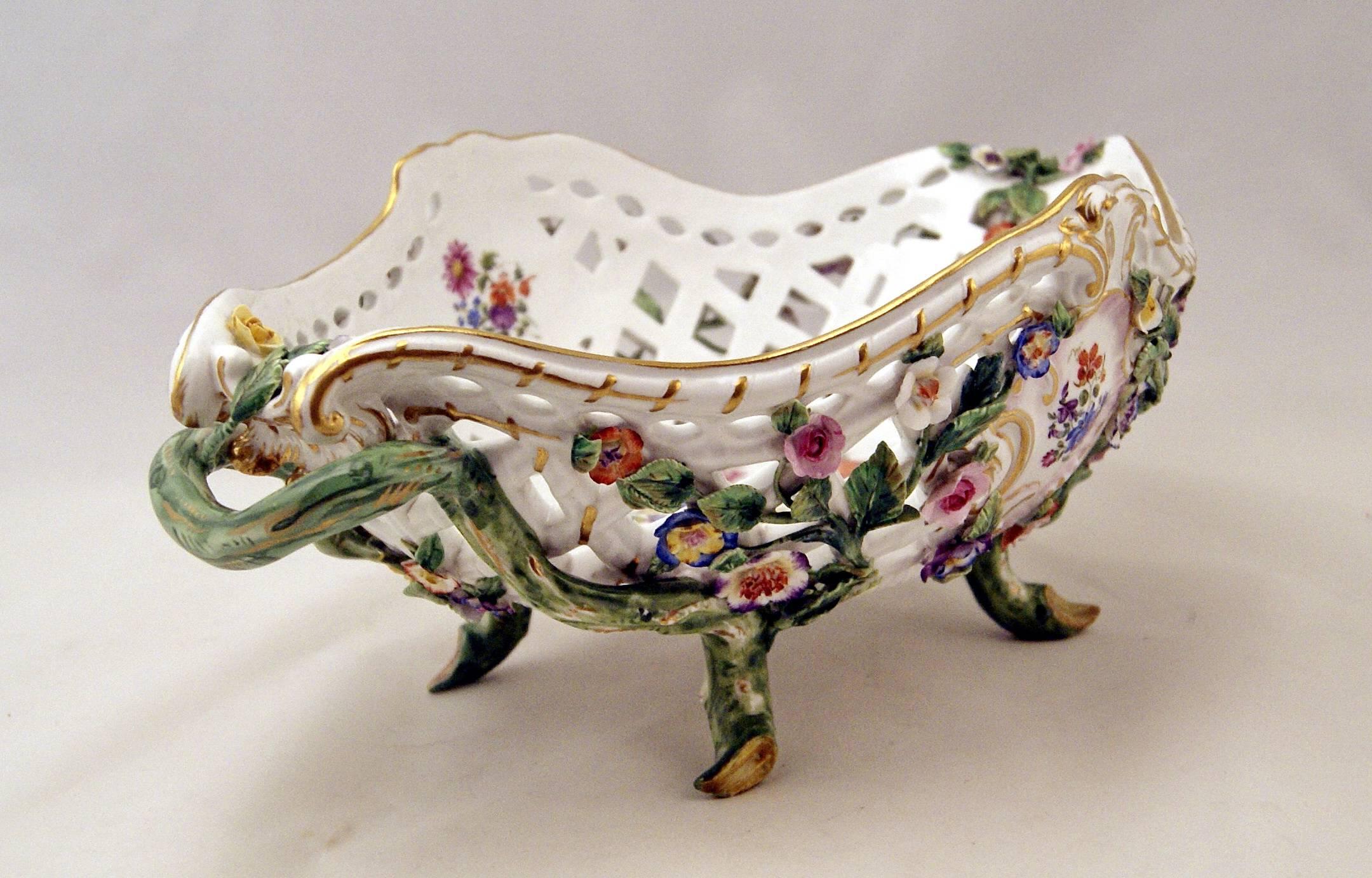 Meissen large oval reticulated basket bowl decorated with sculptured flowers, attached to stems with leaves, based on feet shaped as branches. 

MANUFACTORY:  MEISSEN
DATING:       MADE CIRCA  1850 - 1860

THE MEISSEN MARK IS WELL VISIBLE AT