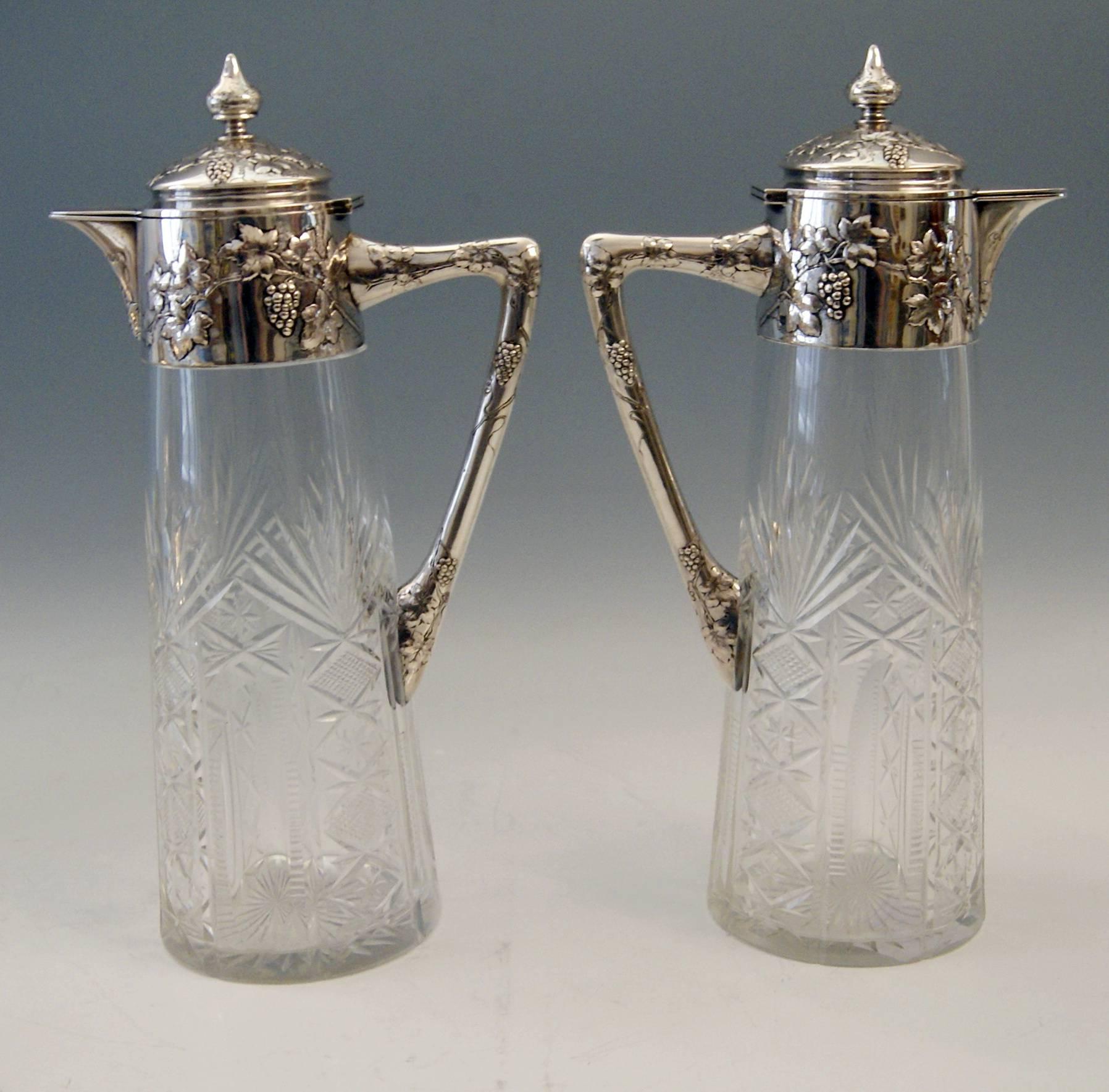 A pair of glass decanters (Carafes) with gorgeous silver mountings. 
Art Nouveau period.

Hallmarked: 
SILVER 800 ( = Hallmarked) and glass (cut decorations).
Austrian official silver stamp: So-said Diana's Head Mark.
made circa 1900.