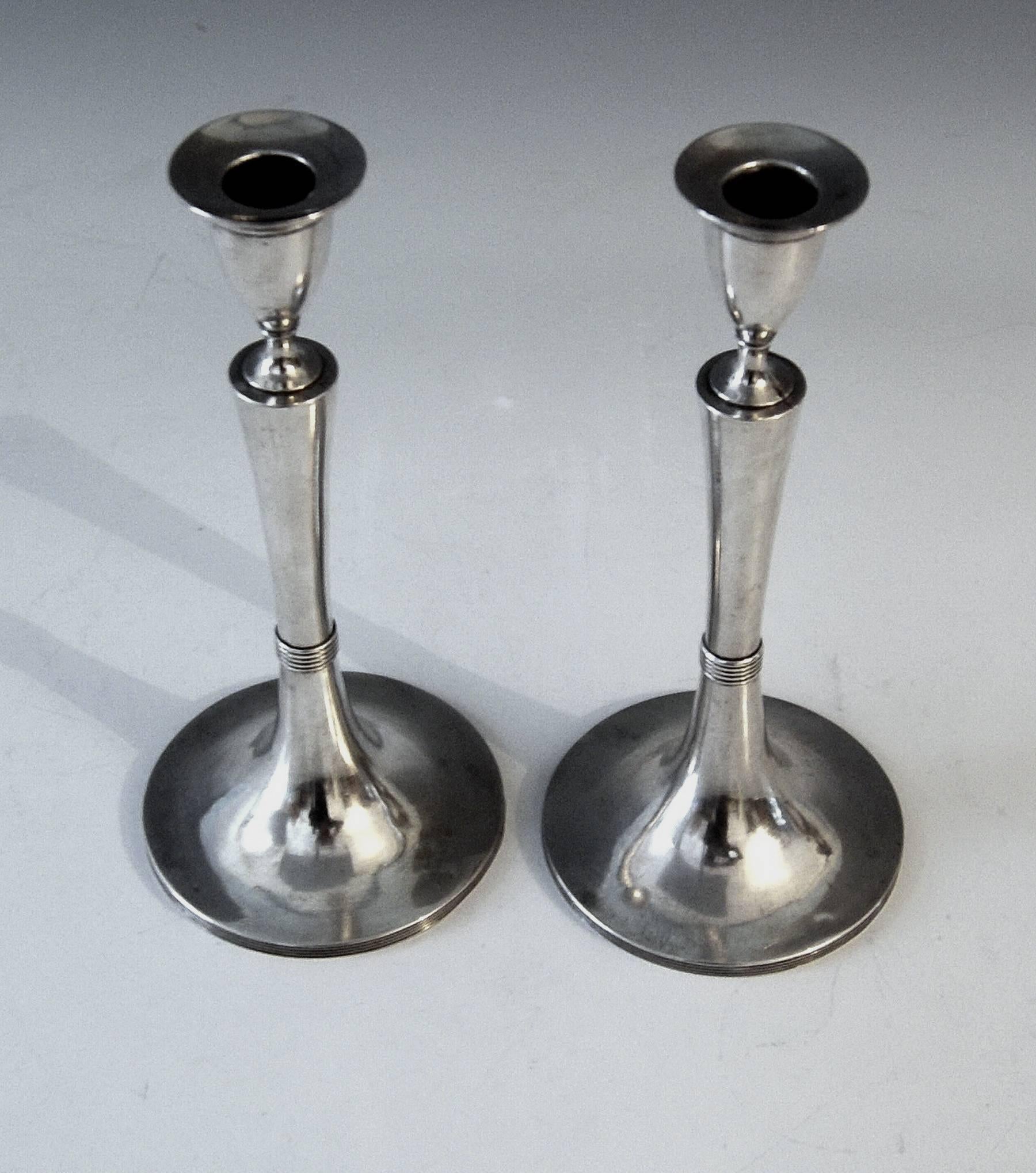 Austrian excellent Empire silver pair of candlesticks
made 1804. 

Very interesting Viennese silver pair of candlesticks of excellent manufacturing quality as well as of elegant appearance:
These candlesticks with smooth surface were made during