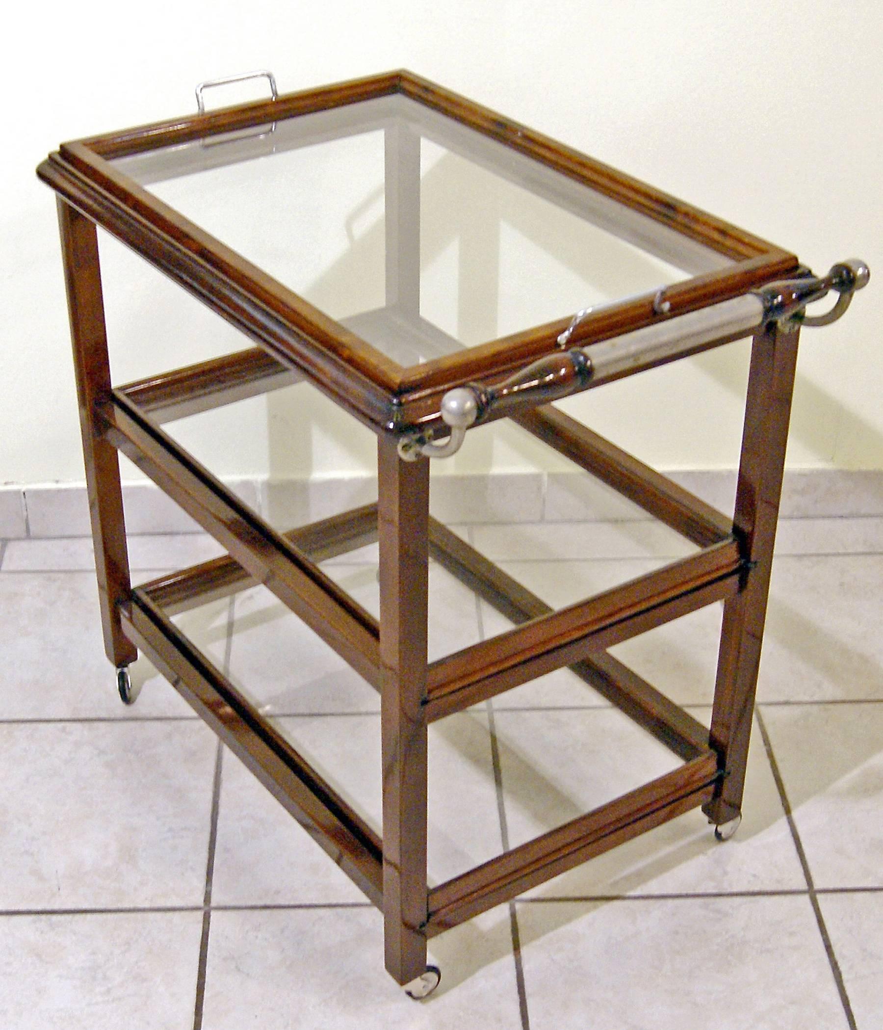 Art Nouveau serving trolley,
Vienna, made circa 1915.
 
Serving trolley of most elegant appearance
(Vintage / Art Nouveau)
nutwood / refurbished by hand.
The serving trolley's shelves are made of glass / the serving trolley stands on original