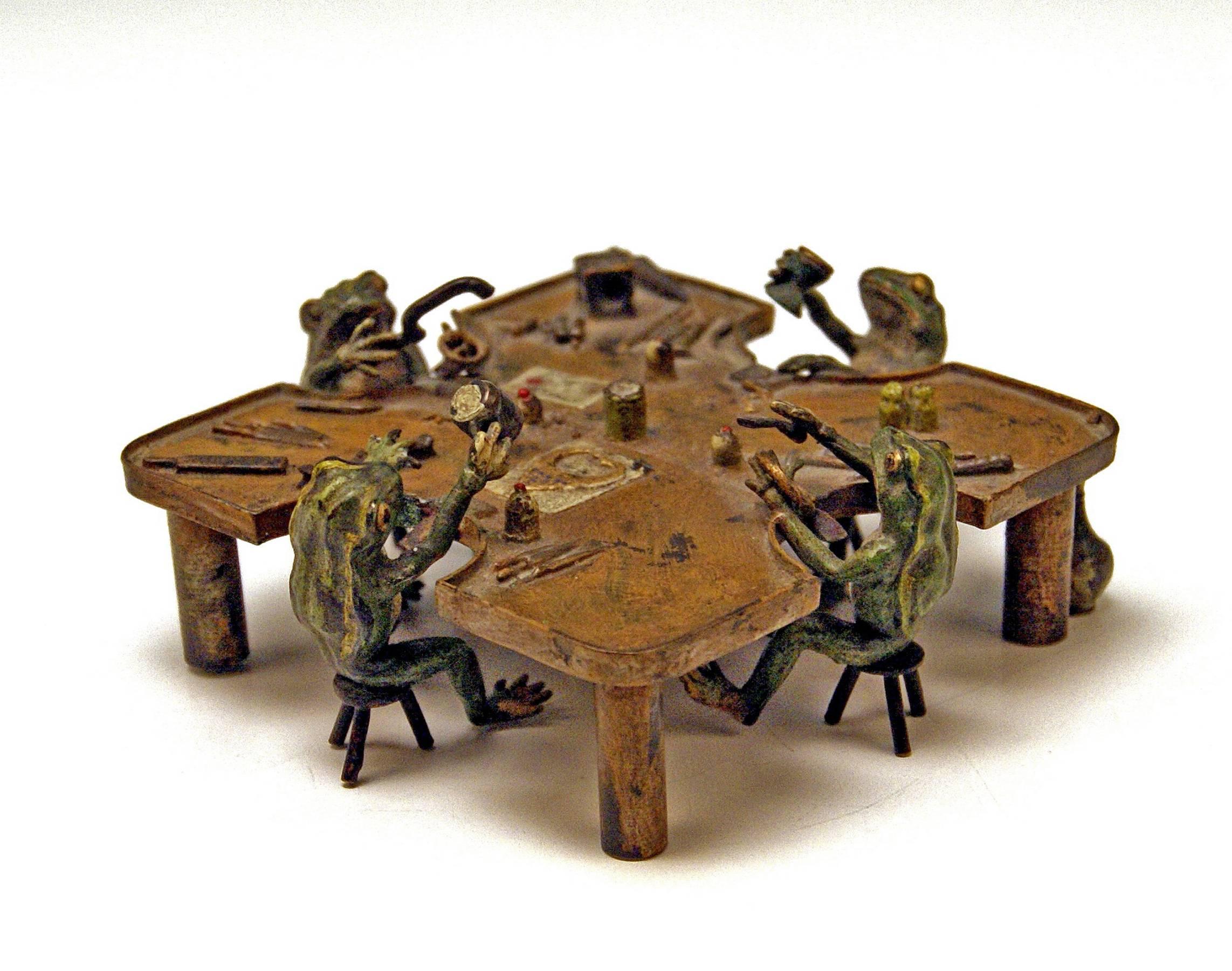 Gorgeous Vienna Bronze Figurine Group manufactured by famous manufactory Bergman(n). Made circa 1890-1900. 

Subject:
Four frogs are gathered around a square table with rounded edges / each of them sits on a tripod stool: They are busy with