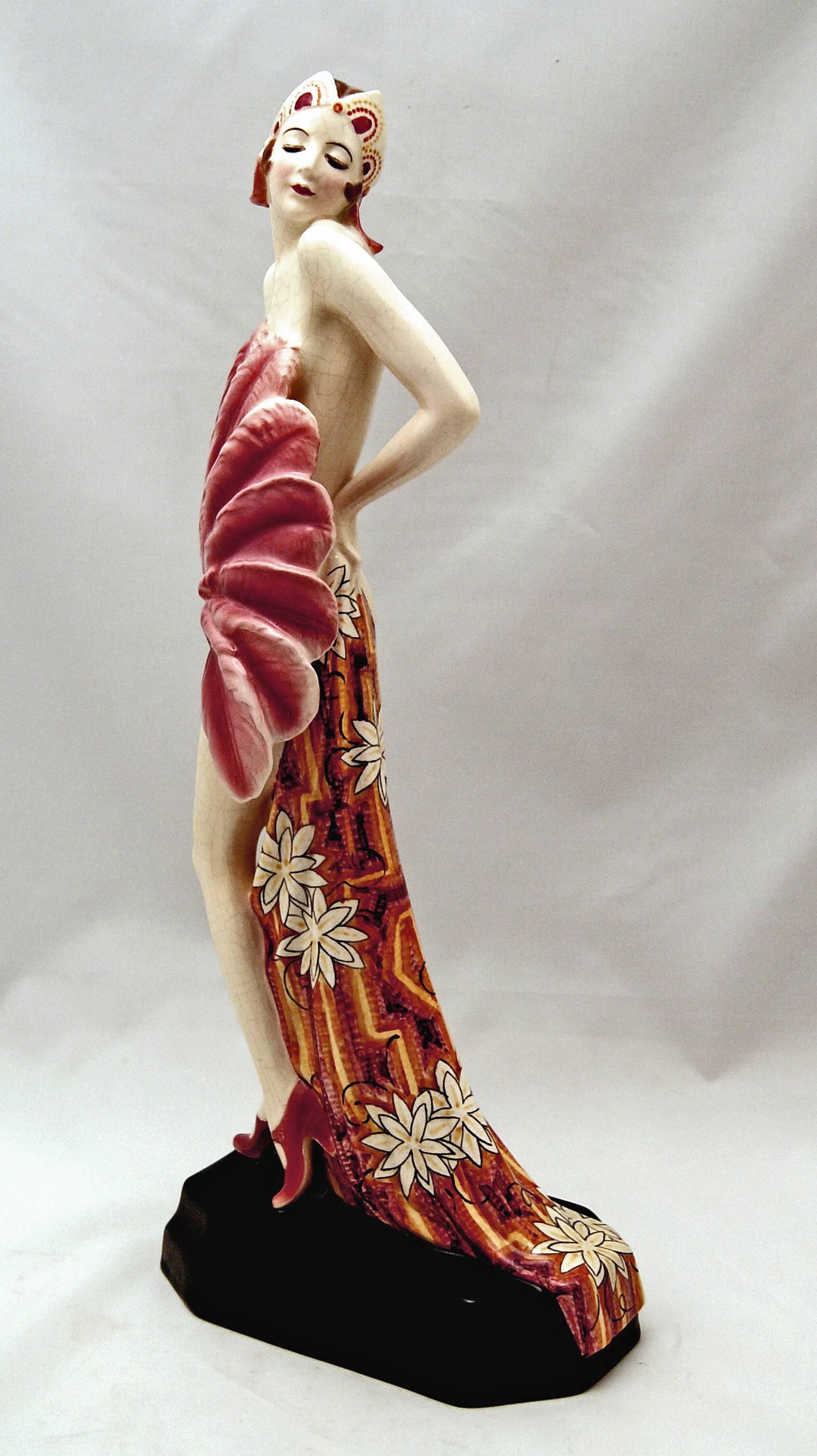 Goldscheider Vienna nicest and rarest posed lady dancer holding a fan made of feathers.

Designed by Stefan (= Stephen) Dakon (1904–1997).
Designed circa 1928/1929.

Made circa 1930.
Model number 5876 / 43 / 8.

HALLMARKED:
Goldscheider