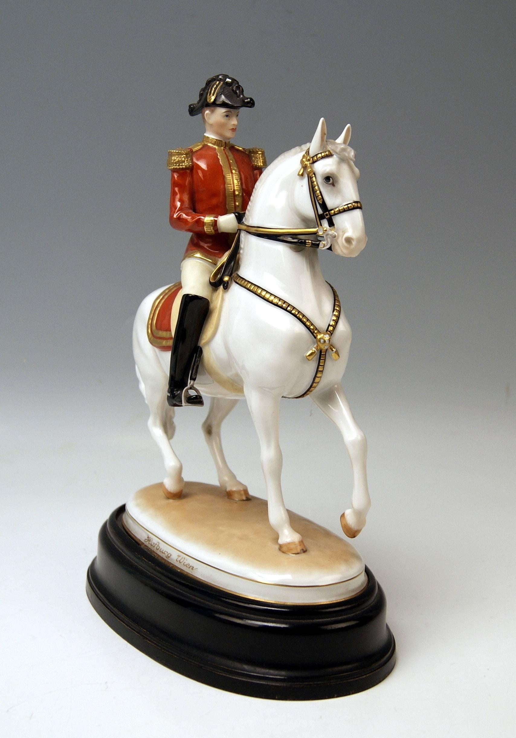 Vienna Augarten horse Spanish riding school.
Figurine Type: Pirouette.

The sitting rider conducts the horse by the reins; he has a sword attached to his red jacket which is decorated with golden borders as well as epaulettes.
The walking horse