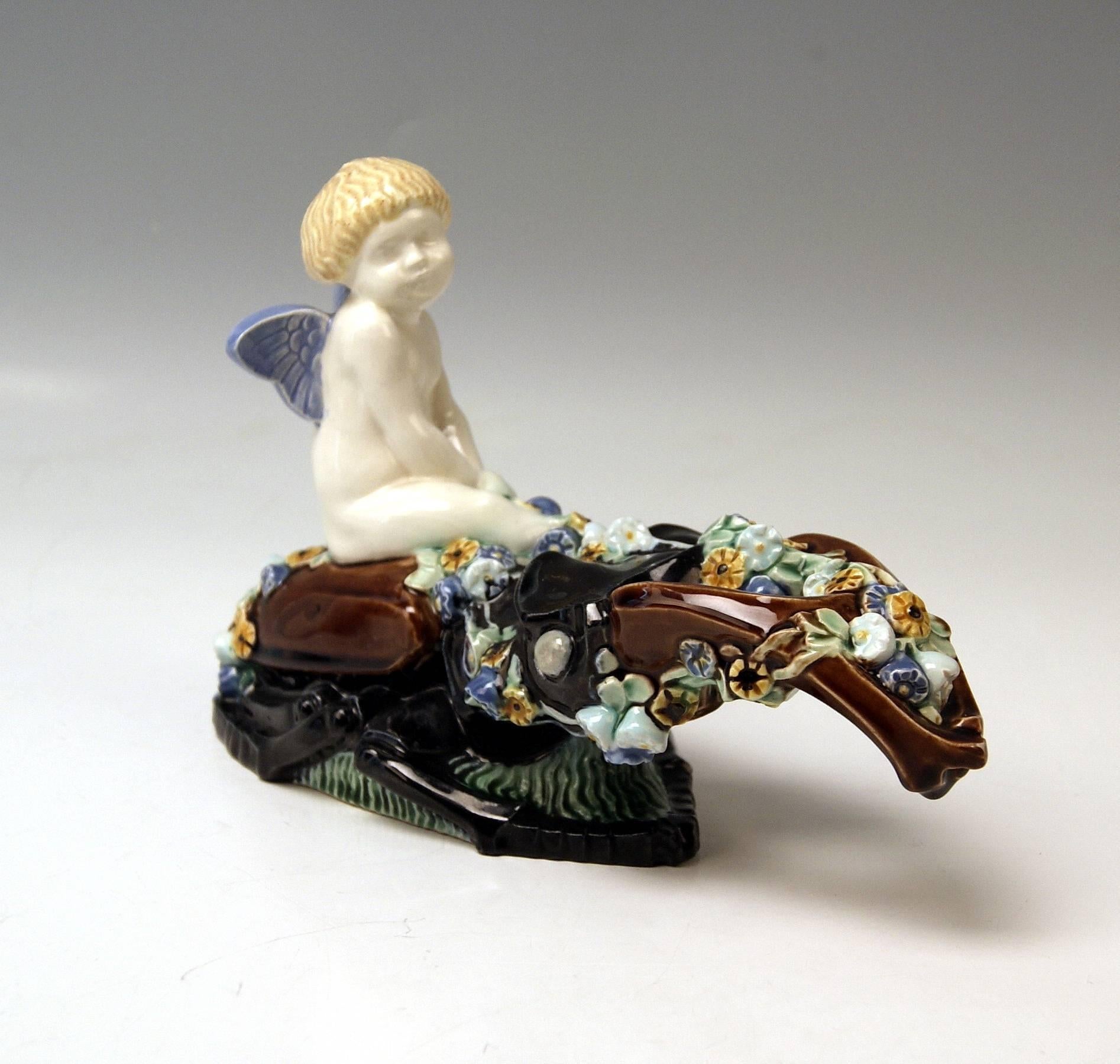 Most lovely figurine: Cherub situated on stag beetle.
Modelled by Michael Powolny (1871-1954) / (model created circa 1907-1908).

Hallmarked:
 Manufactured by Wiener Keramik (Vienna Ceramics) (WK / hallmarked).
 Material is ceramics