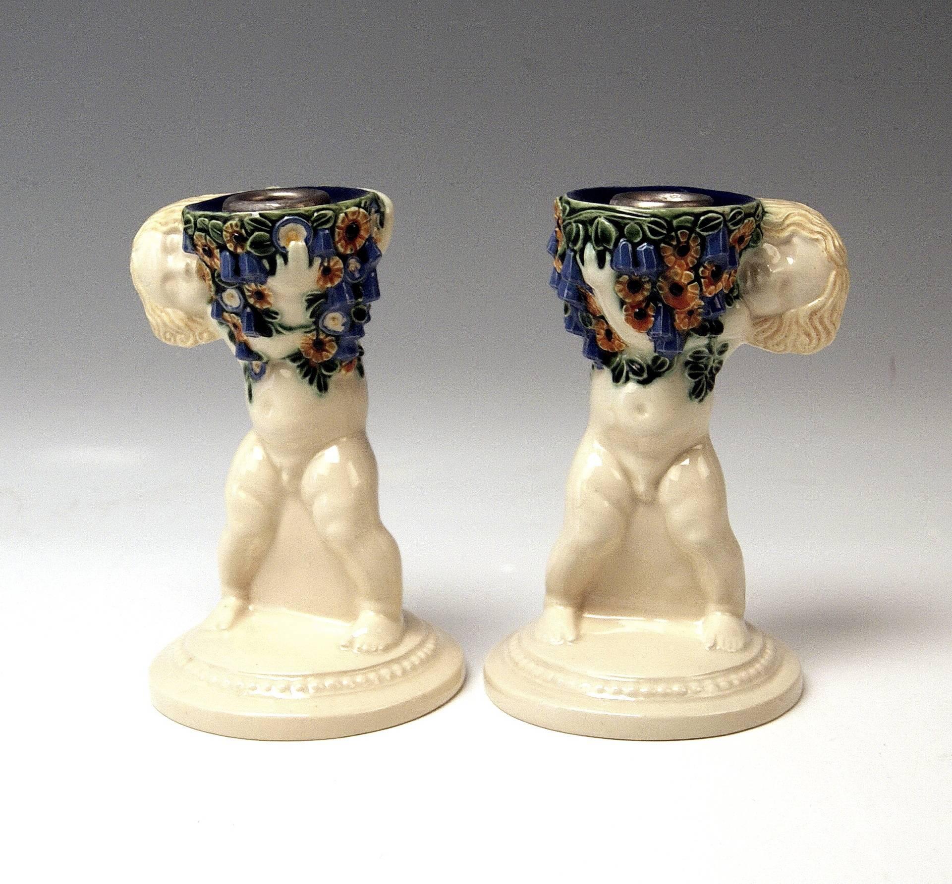 Michael Powolny Art Nouveau pair of candlesticks with cherubs, most lovely ceramics items!
 Modelled by Michael Powolny (1871-1954), before 1912.

 Hallmarked:
 Manufactured by Wiener Keramik (Vienna Ceramics) (WK / hallmarked).
 Material is