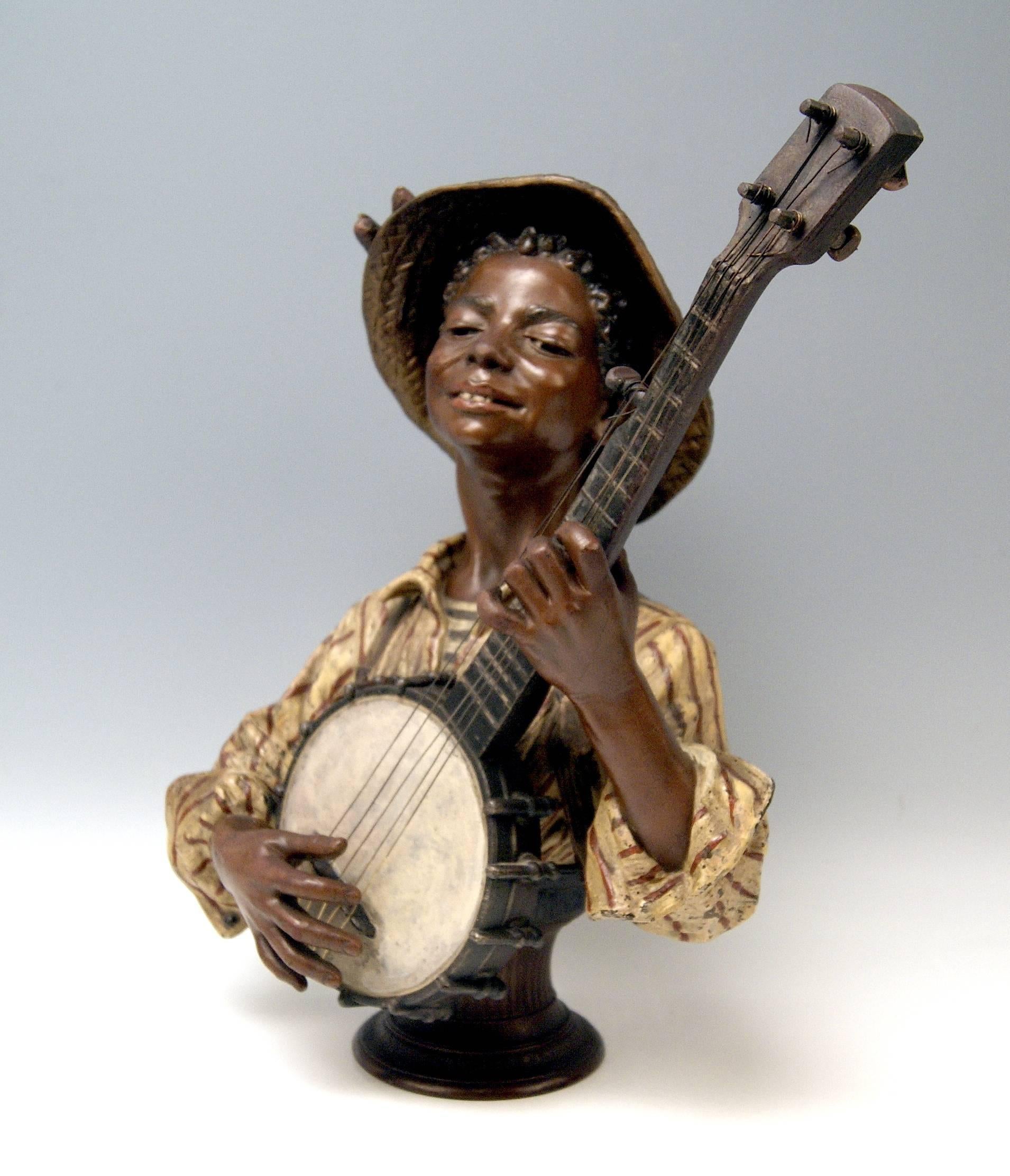 Goldscheider Friedrich bust (made of metal alloy  / painted):
Black boy playing banjo (=  an american instrument).
Made by Goldscheider French Manufactory in Paris: Founded in year 1892 by Friedrich Goldscheider (1845-1897) / the manufactory was