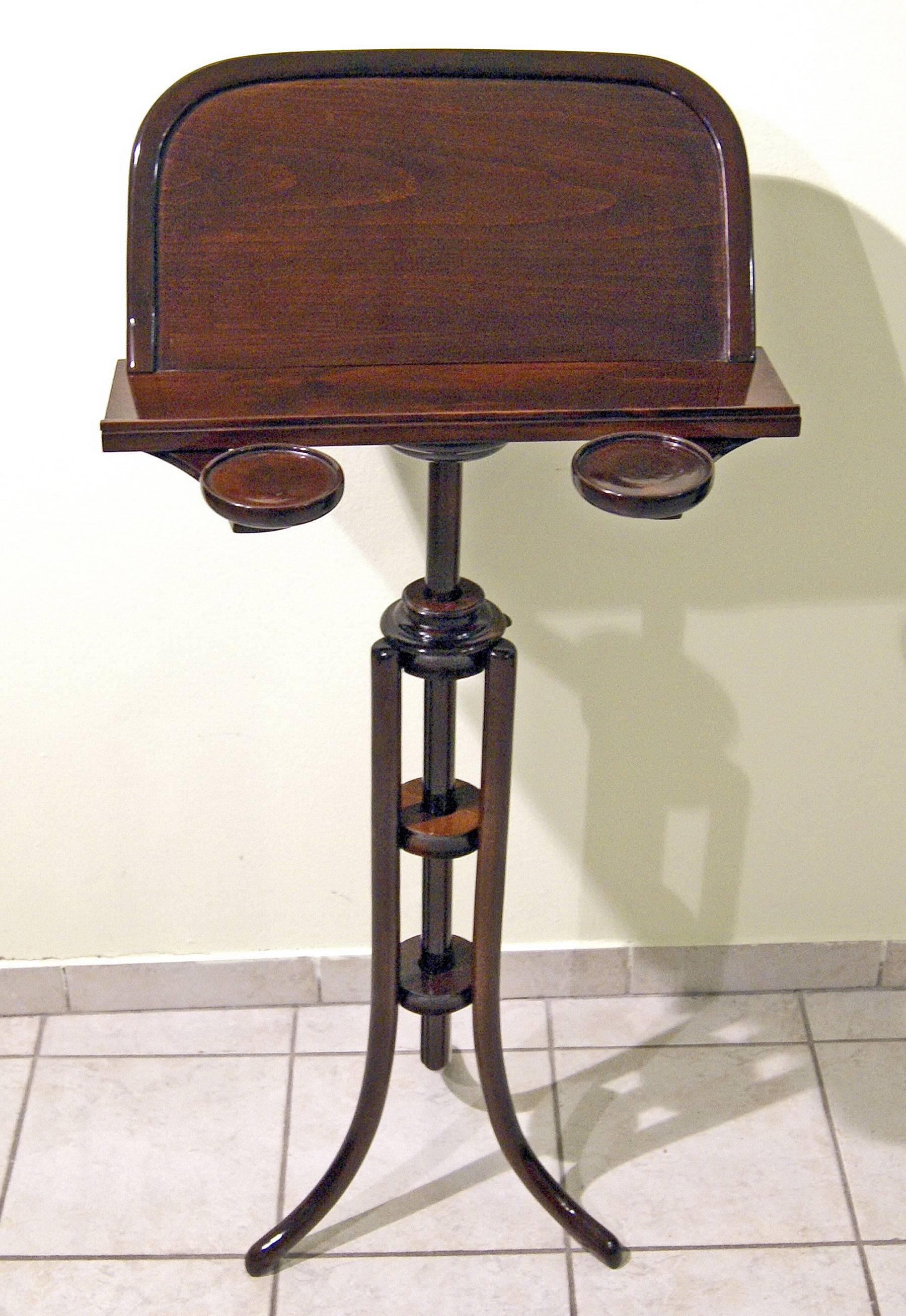 Thonet music stand
Model number 11852 (authenticity guaranteed!)

beechwood, dark mahogany stained/high quality handwork.
This music stand is of most elegant impression, indeed (the wooden parts are bent in finest Thonet manner!): It stands on