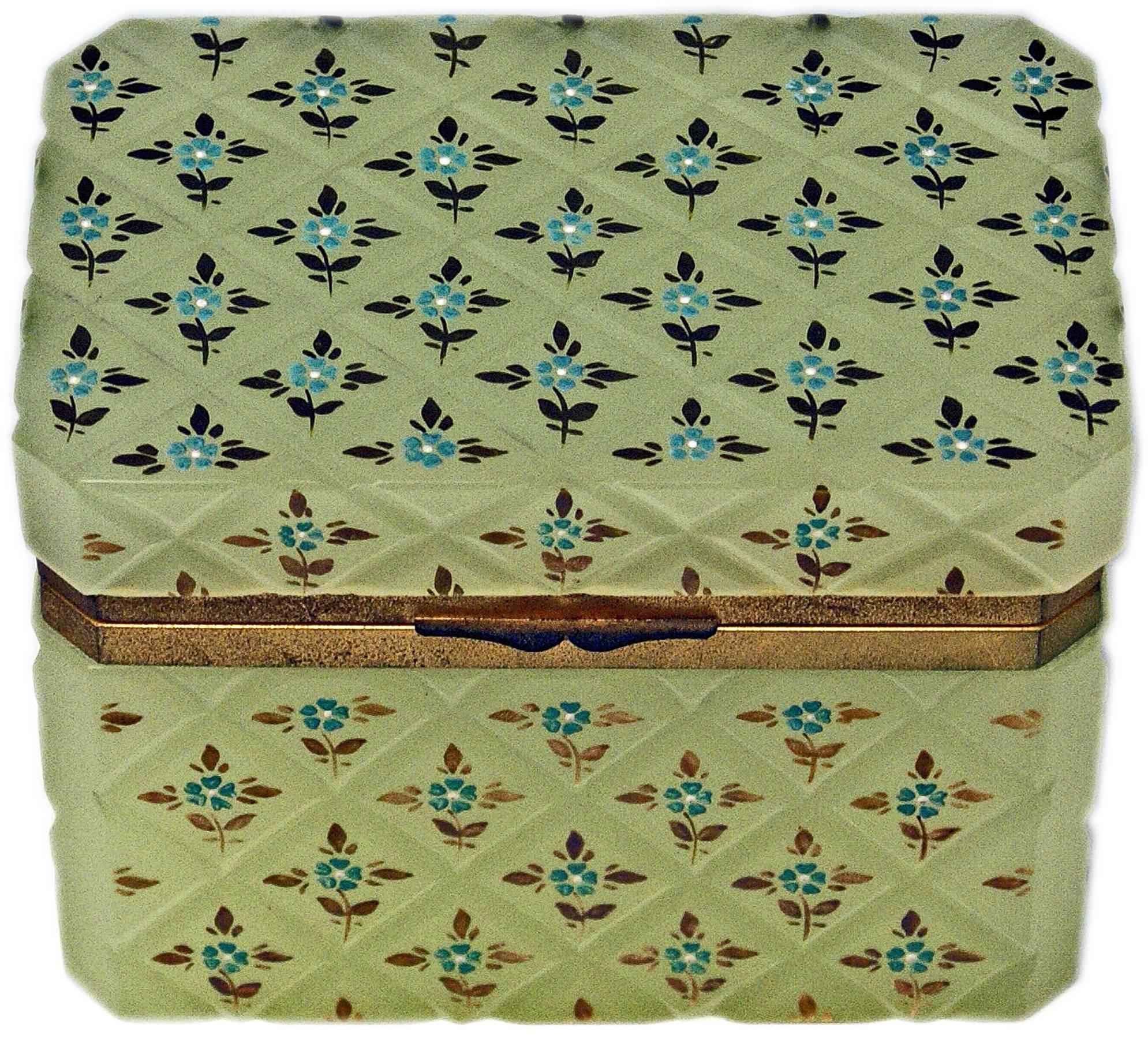 Specifications:
Opaline pastel green box with hinged lid having gilt bronze mountings or the lid closes properly. The casket's surface with splayed edges has an overall crosshatched pattern with small flower's blossoms surrounded by golden leaves