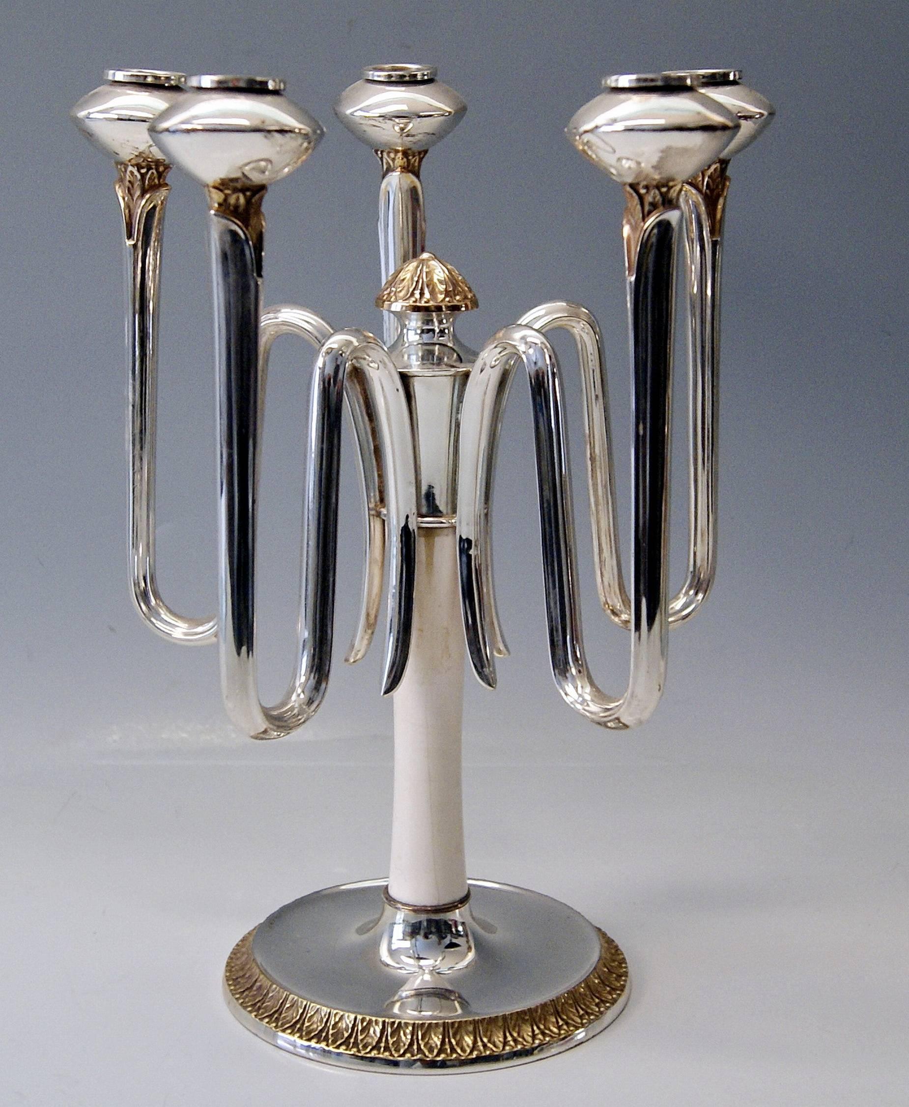German excellent pair of Art Deco silver candleholders,
made circa 1930. 

Gorgeous Art Deco Pair of Branched Candleholders / Candelabra made circa 1930 by Otto Wolter / Schwaebisch-Gmuend  (Germany). 
These most elegant candleholders have five arms