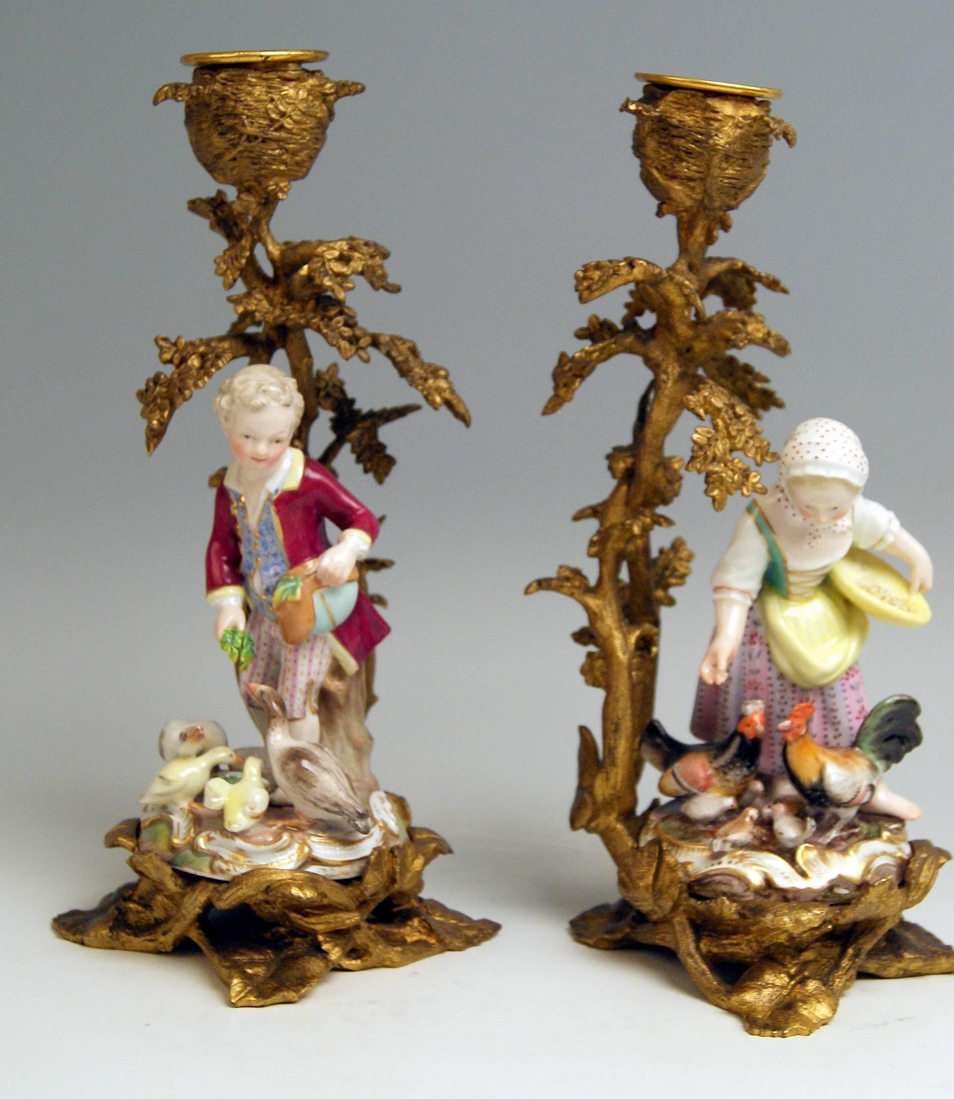 Meissen most remarkable pair of figurines:
Boy and girl feeding geese and chickens, each of them attached to fire-gilt candlestick made of bronze.

Measures / dimensions:
height 4.72 inches / 12.0 cm (male gardener / figurine only)
height 4.52