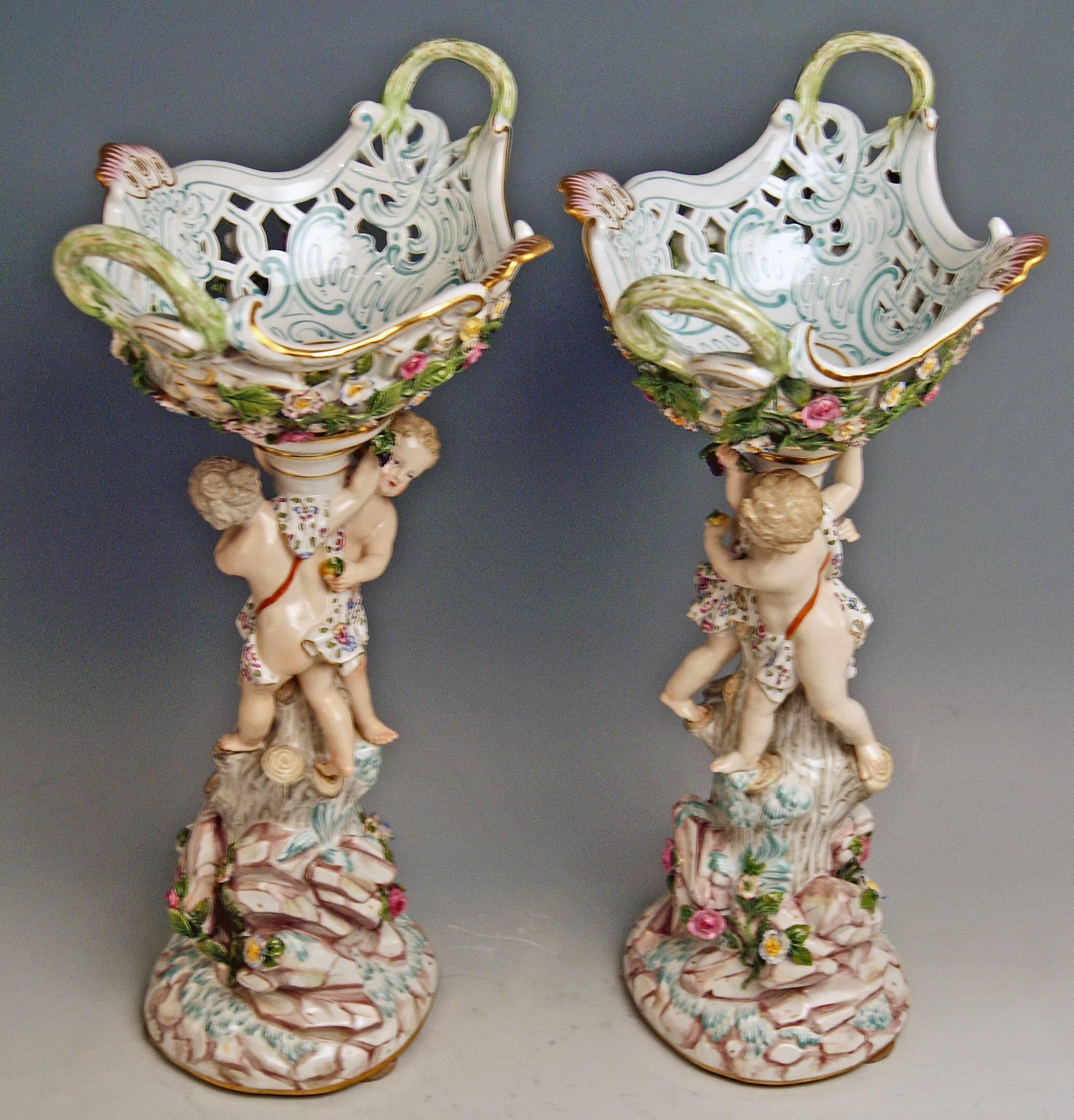 Meissen a pair of most remarkable centrepieces / fruit bowls: each of them decorated with a pair of cherubs (male and female)

Measures / dimensions: 
height 16.14 inches
width of basket 9.055 inches
depth of basket 7.28 inches

Manufactory: