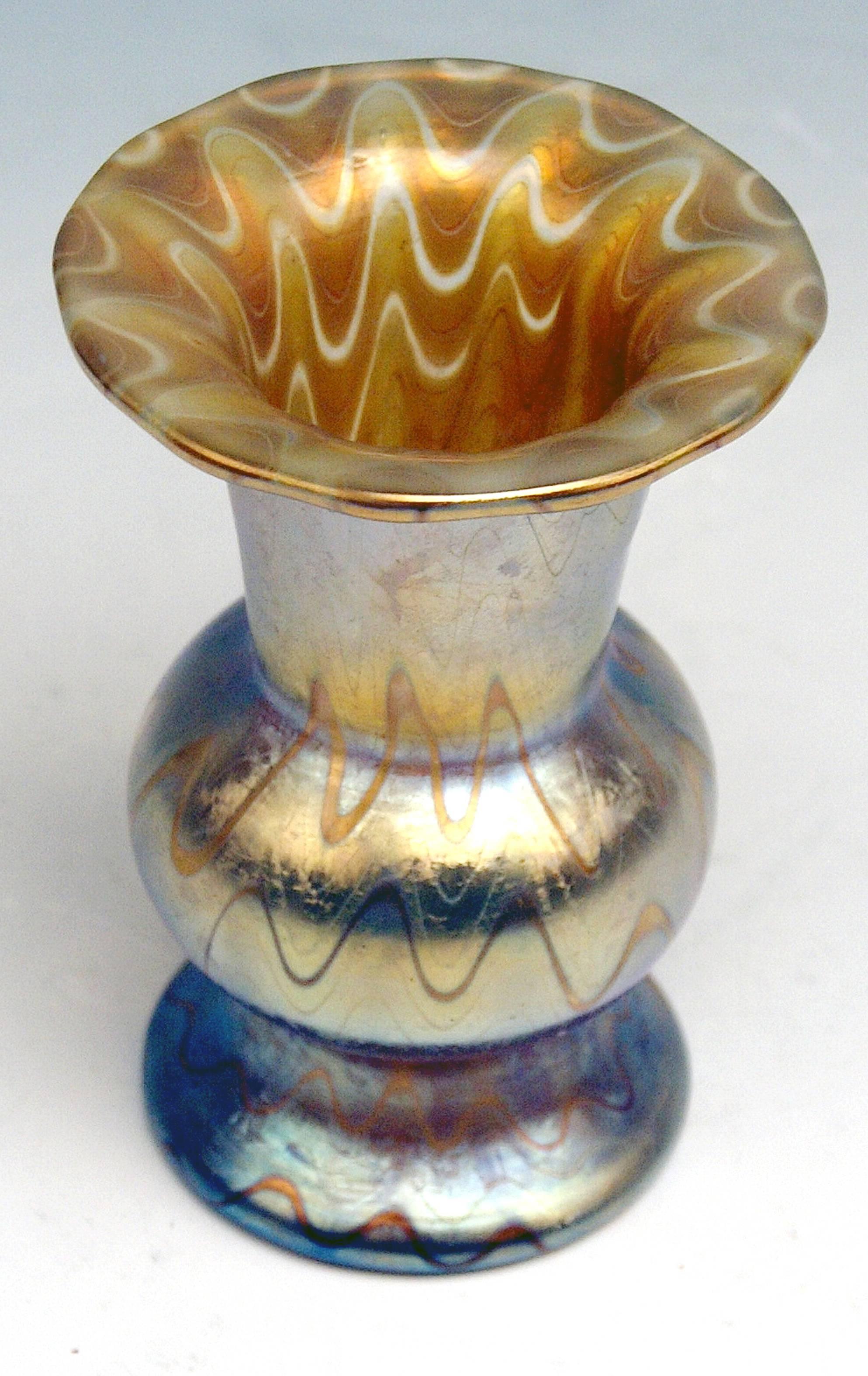 Vase Loetz Widow Klostermuehle, Bohemia, Art Nouveau 

Made by Loetz, Klostermuehle (Klostermühle / Bohemia) / circa 1900
Decor: Phaenomen Genre (PG 6893 / golden shaded)

This small nicest Loetz Art Nouveau Vase is of interesting form type: