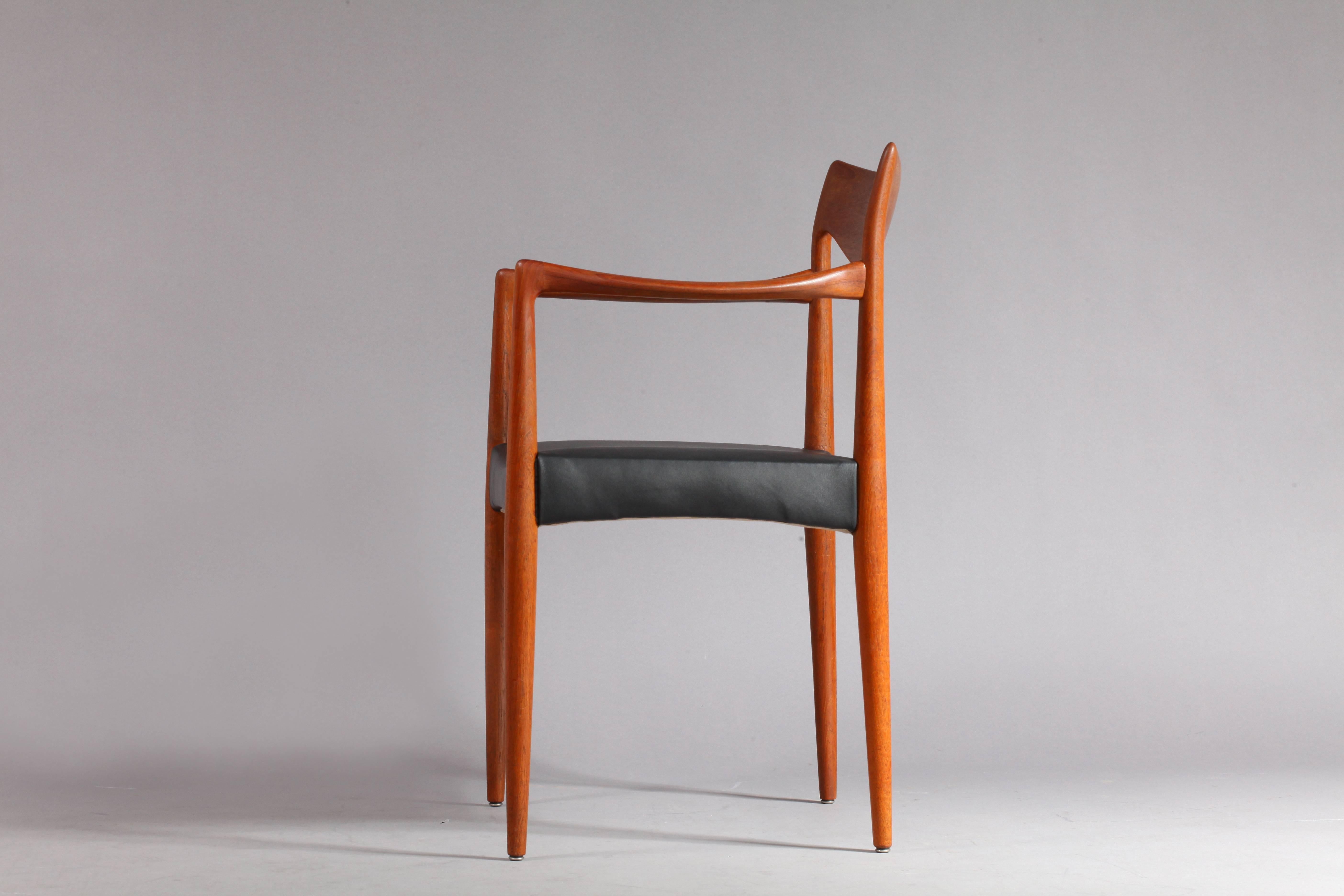 Two armchairs,
Norwegian Bambi-chair model 63 made by Gustav Bahus, design Rastad & Relling.
Denmark, 1950.
Solid teak, black leather.
Measures: Height (80cm),
width (58cm),
depth (47cm),
seat height (18cm).