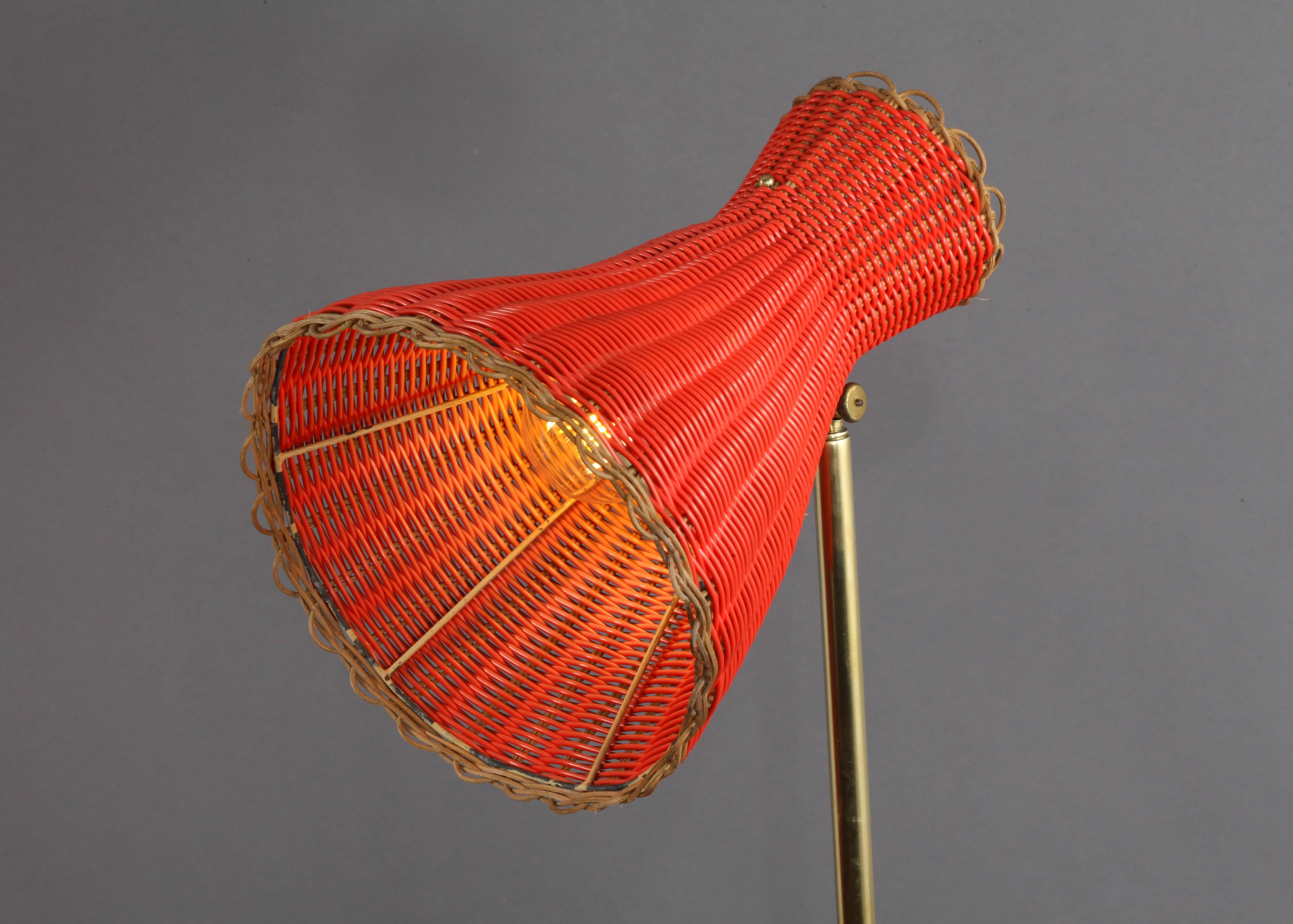 Floor lamp,
designed Rupert Nikoll,
Vienna, 1950.
Black lacquered base, brass stam.
Movable woven red bast shade.
Measures: Height 60 inch.
 