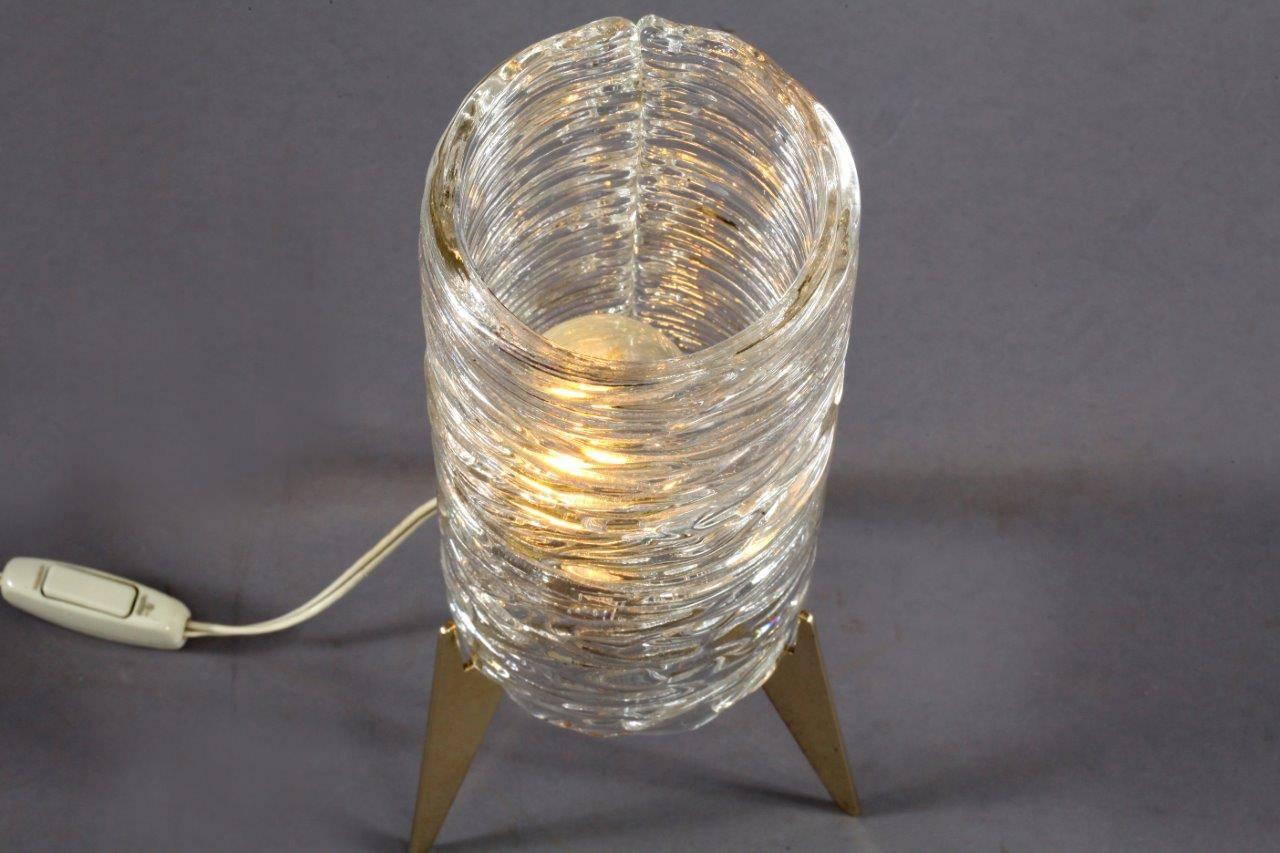 Table lamp,
designed and produced by J. T. Kalmar,
Vienna, 1960.
Tripod brass base, ice glass shade.
E 27 60 watt bulb socket.