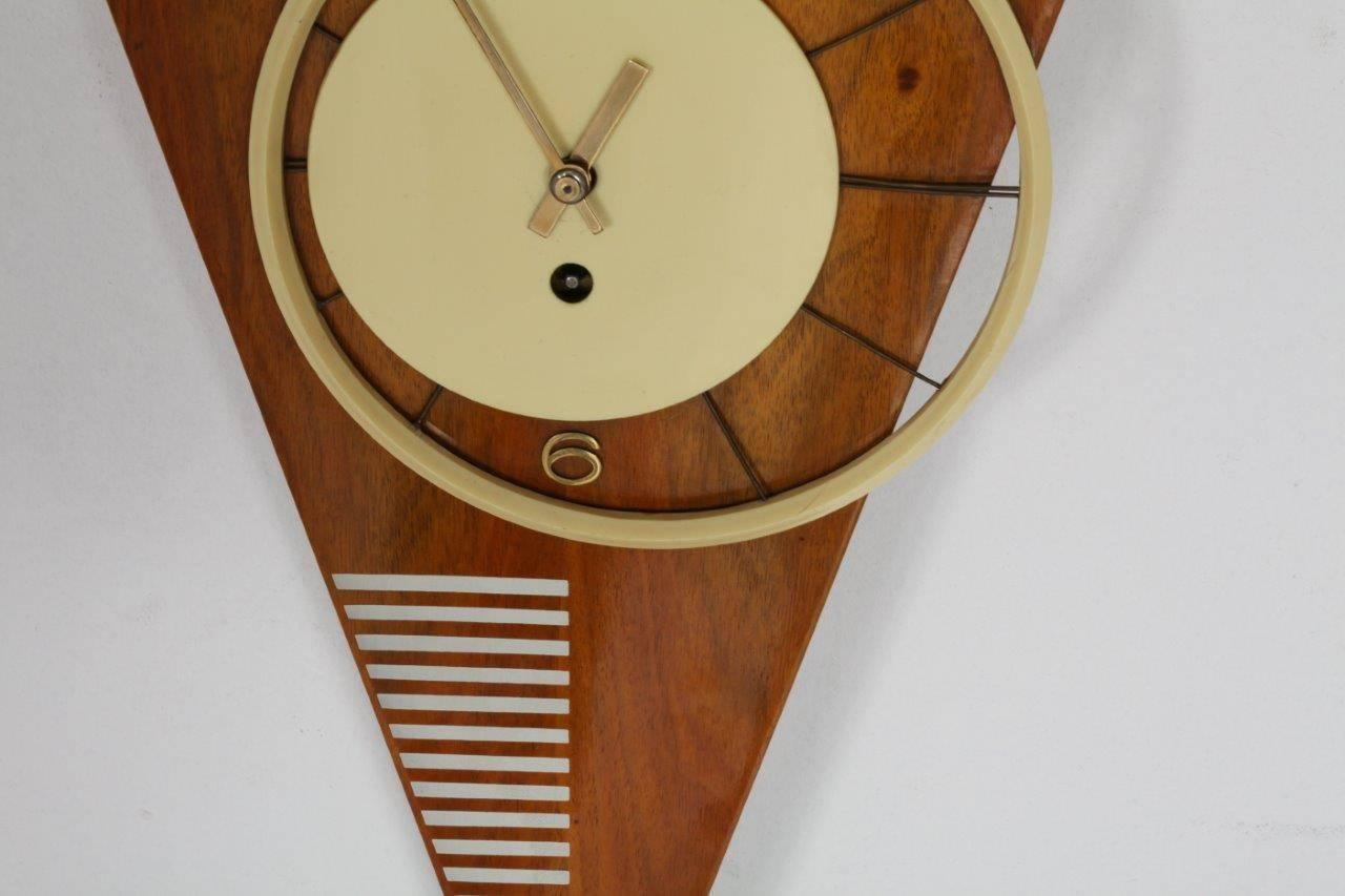 Asymmetric triangle wall clock,
24 hour movement in working condition,
Vienna, 1950.
Walnut, brass fingers.