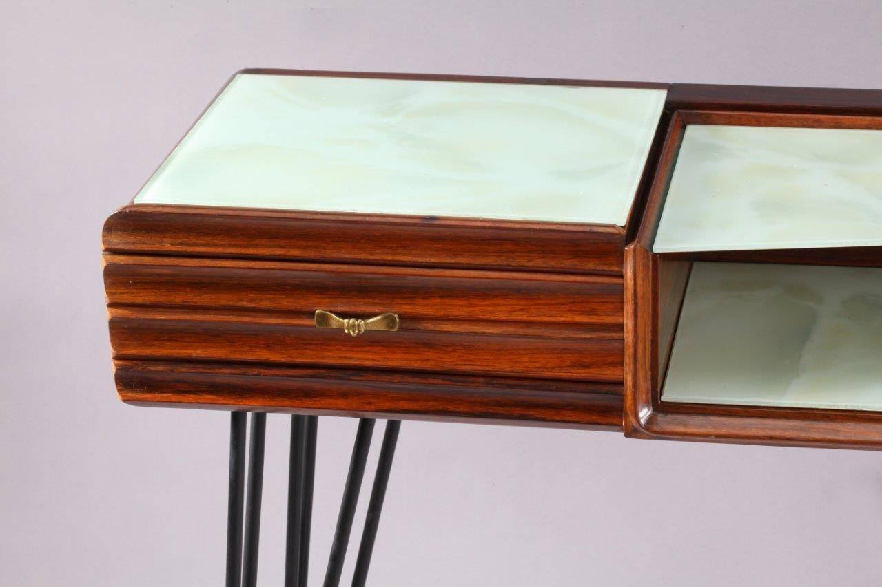 Console table,
Italy, 1950.
dark walnut, one drawer, glass shelves,
black laquered metal triangle legs.
dark walnut