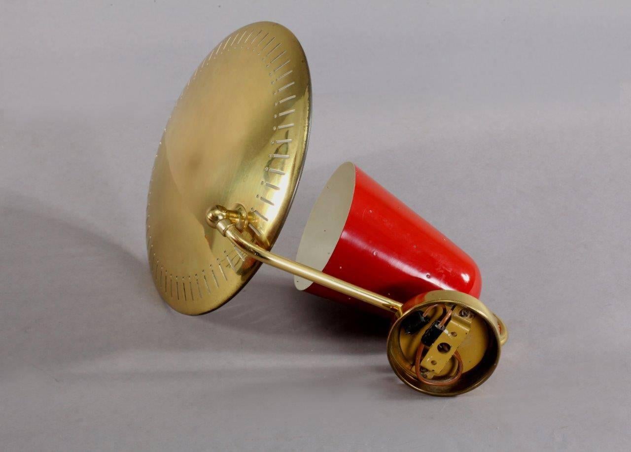 Wall lamp,
attributed Arredoluce.
Italy, 1950.
Brass base, red laquered cone, movable reflector in brass.