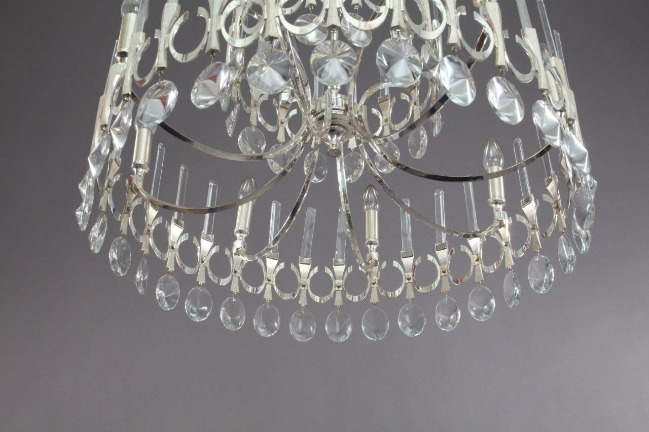 Gaetano Sciolari,
Italy 1960.
Very big Sixteen-light round chandelier with crystal pendants and fixed crystal rods on three levels. Wiring has been checked and confirmed to be sound, newly cleaned.