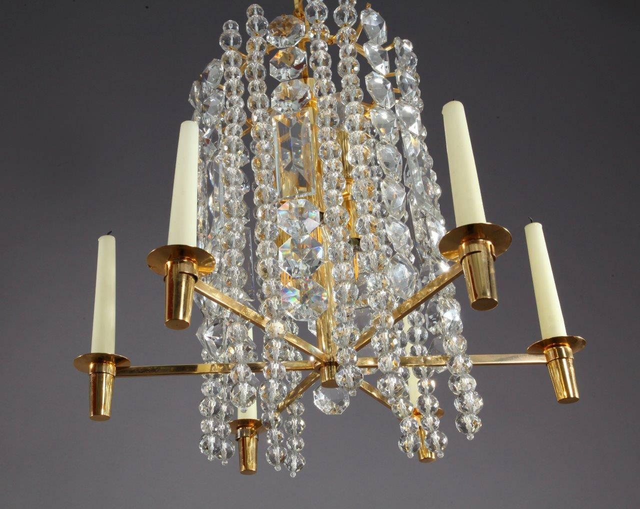 A unique and high quality gold-plated chandelier or pendant light by Bakalowits & Soehne, Austria, manufactured in Mid-Century, circa 1960.
The light fixture is made of a gilded brass frame and chains in different lengths decorated with hand cut
