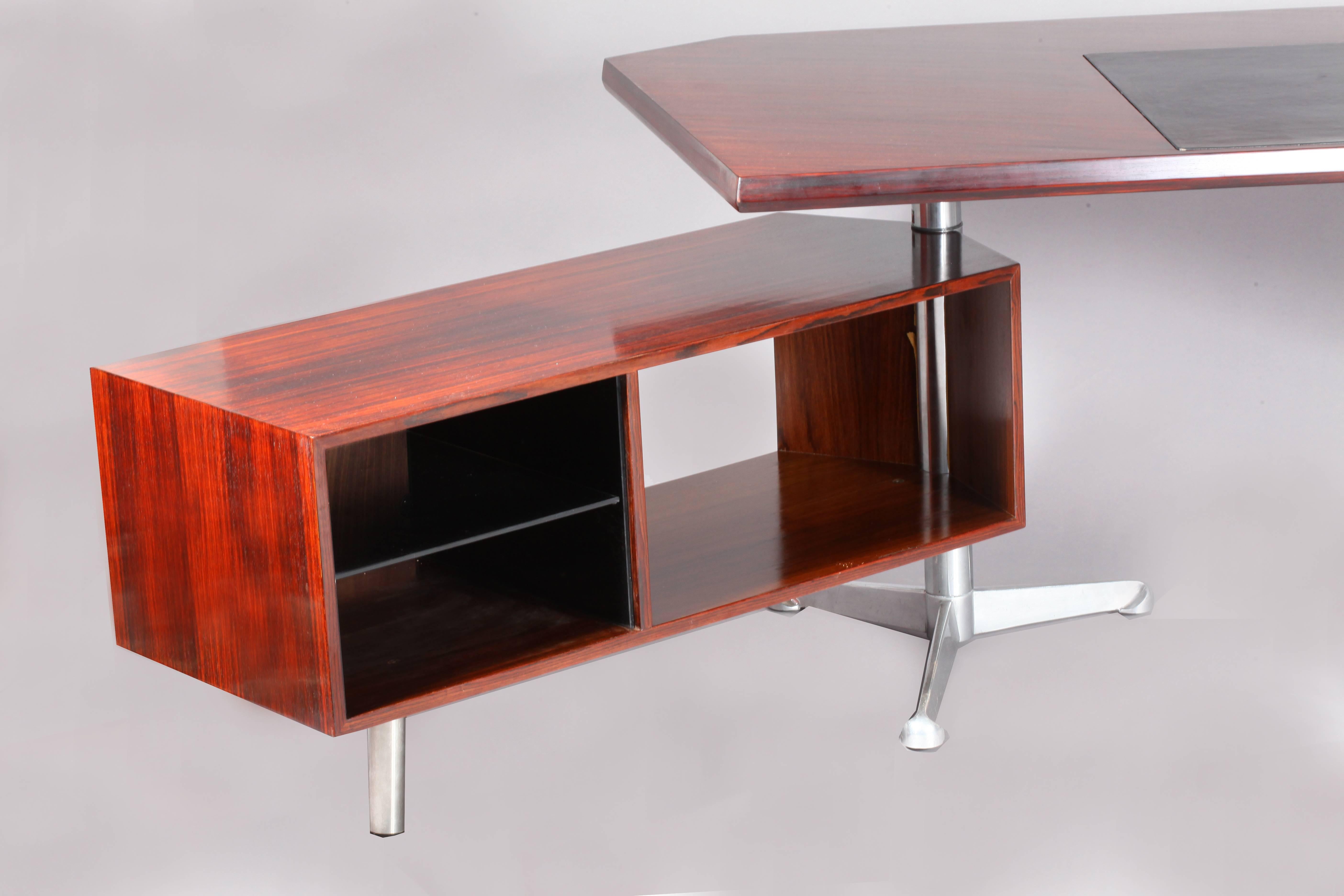 Architectural rosewood executive desk by Osvaldo Borsani for Tecno Milano. rosewood hand polish with wood grain showing through. Floating pedestal on right side and longer return on left, both rotate 360 degrees. Original working lock on the right