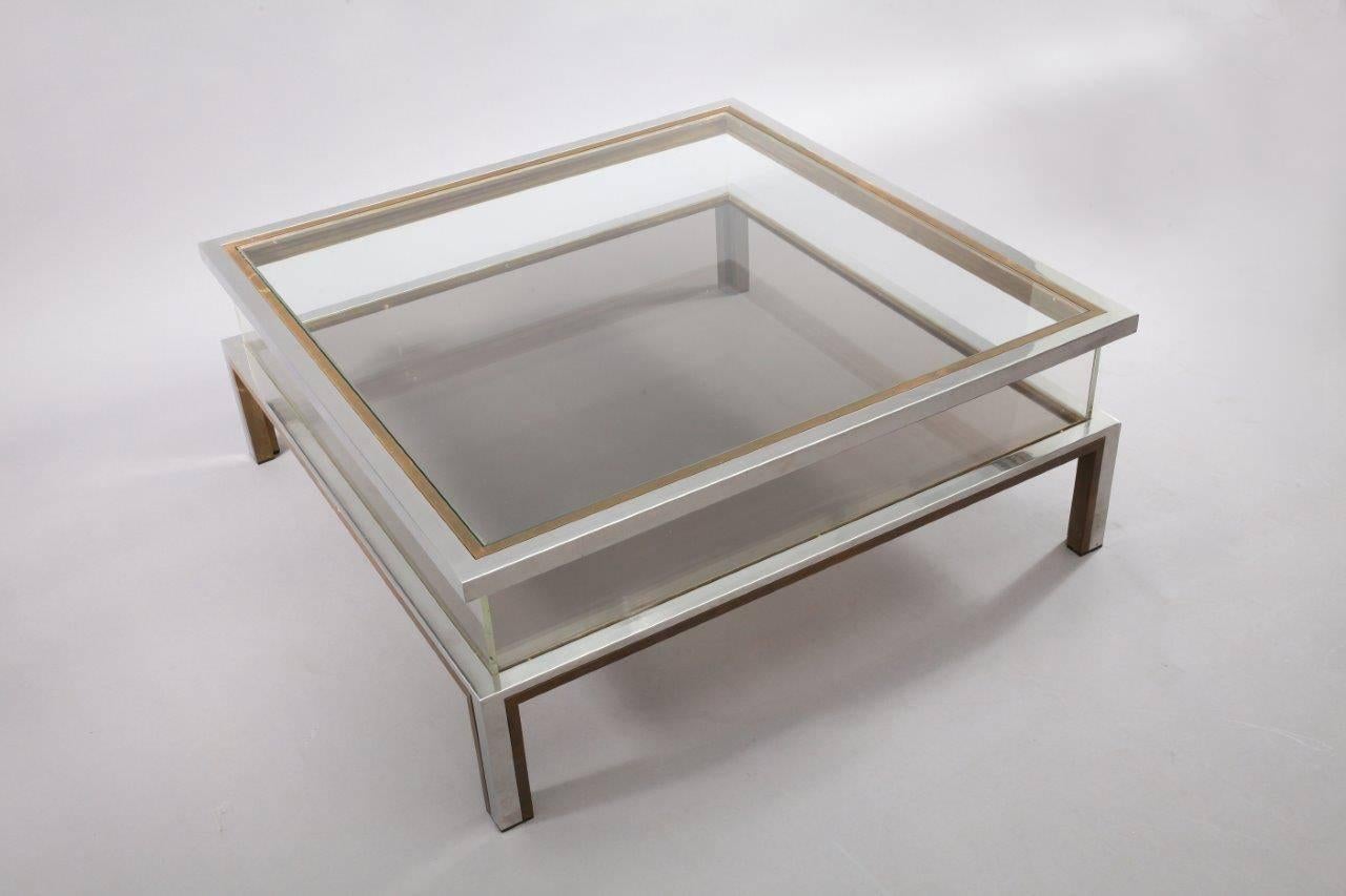 Maison Jansen sliding top coffee table in brass and chrome,
France, 1970.
The top can slide open to reveal the inside compartment that can be used as a vitrine for books and magazines.
       