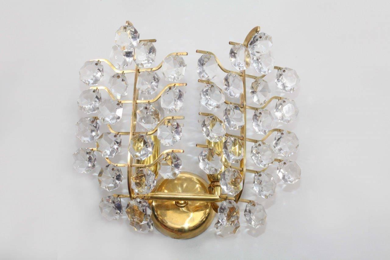 Pair of crystal glass wall sconces
Bakalowits und Söhne
brass, crystal glass
each sconce have four bulb sockets.