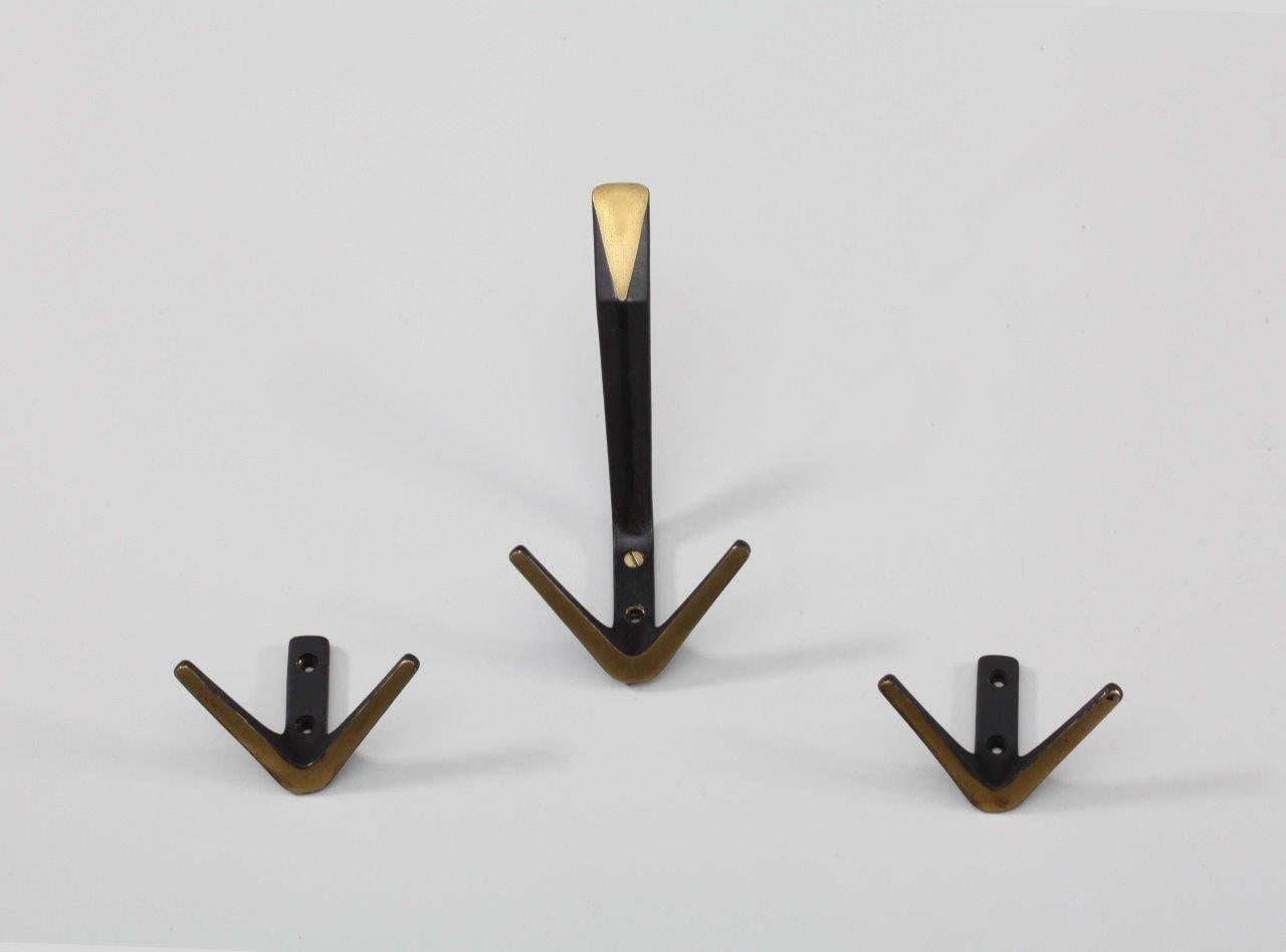 Four small and four big hooks with fitting brass screws
Brass, black colored brass.