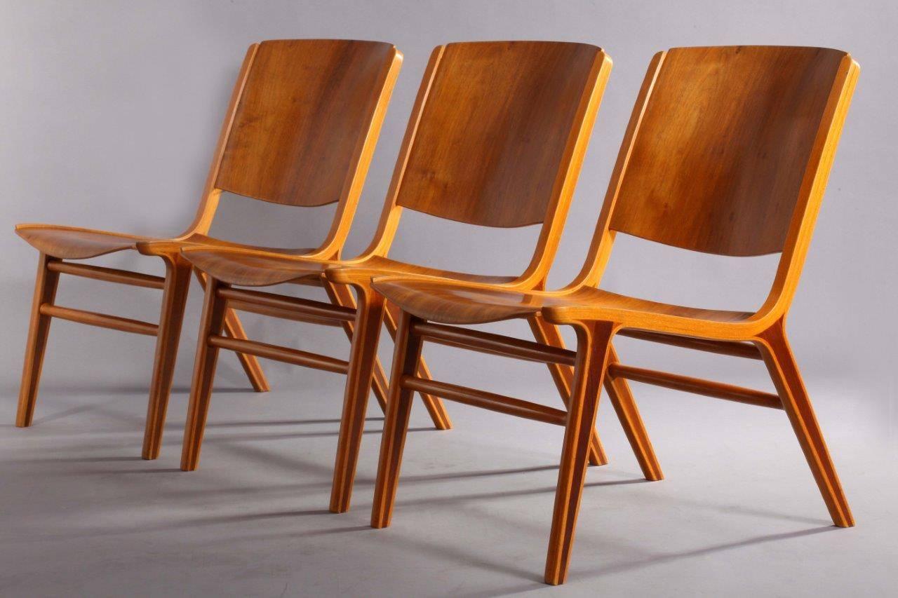 Three Classic 'AX' chairs designed by Peter Hvidt & Orla Mølgaard Nielsen for Fritz Hansen in 1950. This chair features a birch ply frame with inset mahogany in the legs and a bent teak back and seat.
