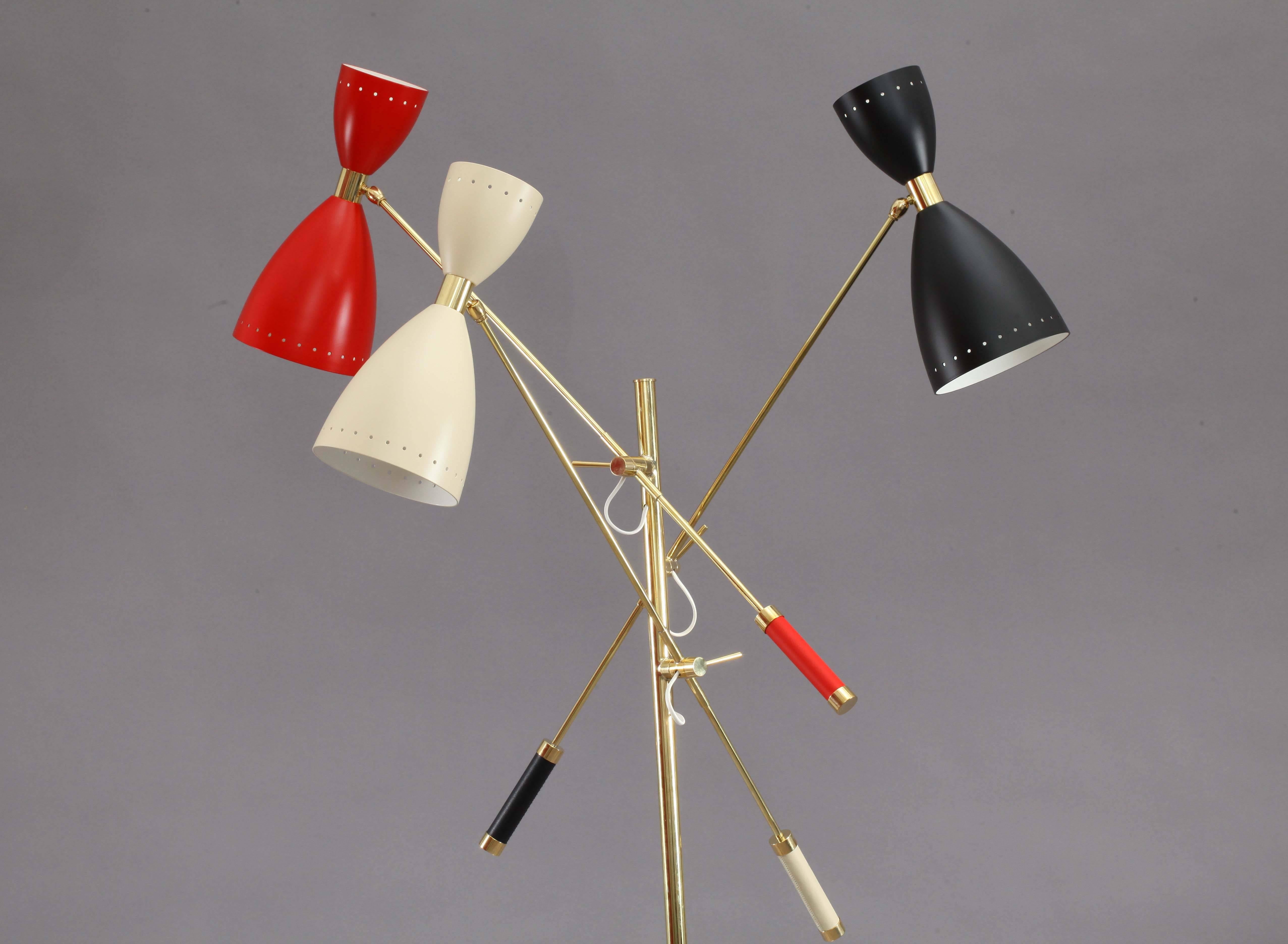 Italian floor lamp,
in the manner of Stilnovo,
round marble base,
brass stem with three movable arms and colorful movable cones.
Each one with one E27 and E14 bulb.
Leather grip.