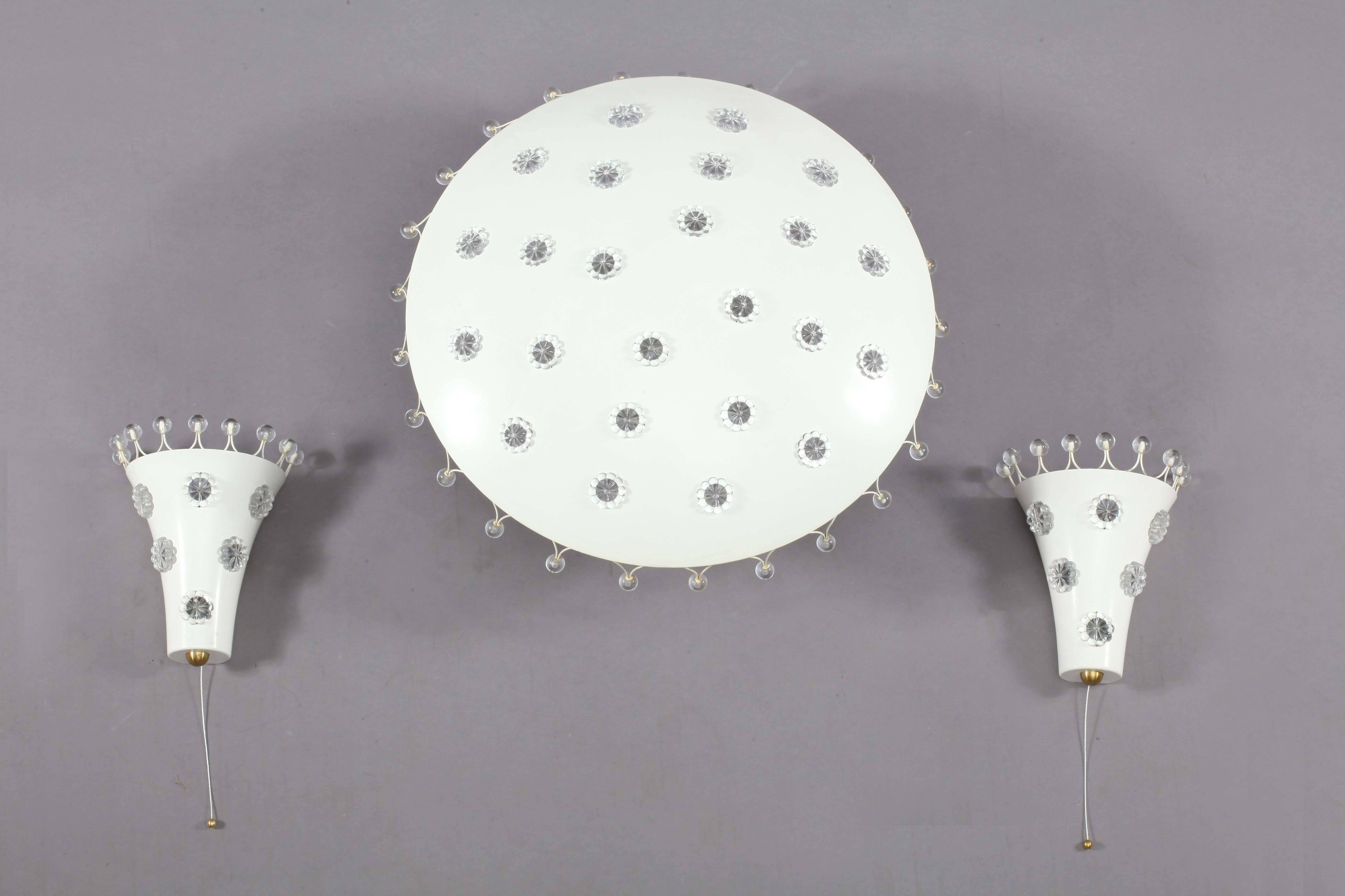 Two wall sconces and a ceiling flush mount,
Rupert Nikoll,
Vienna, 1950.
Lacquered metal, crystal flowers glass balls.