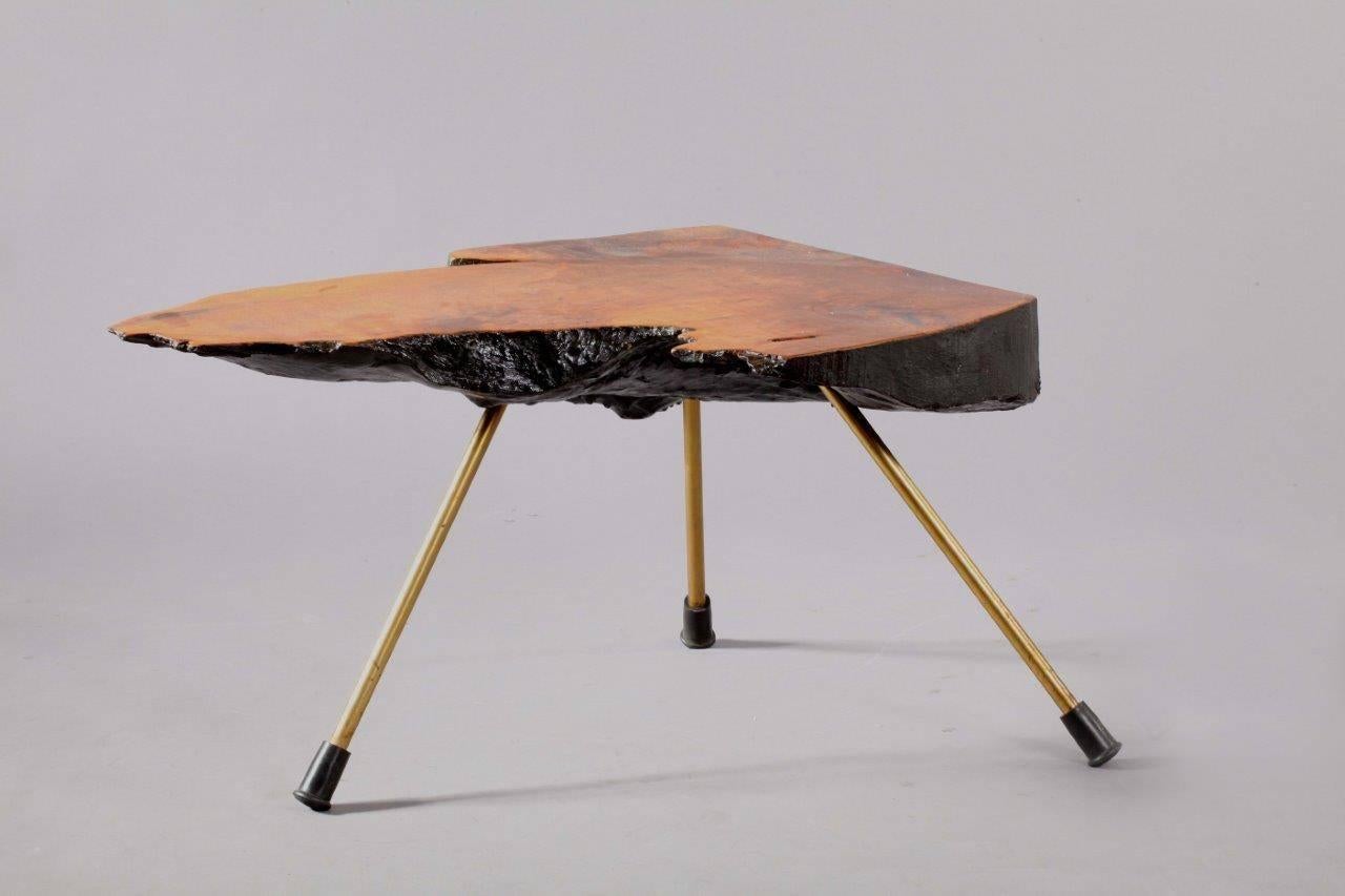 Tree trunk table,
in the style of Carl Auböck,
Vienna, 1950.
Austria.
Solid walnut, stamped with number 4 at the black bottom,
brass legs, later rubber shoes.
