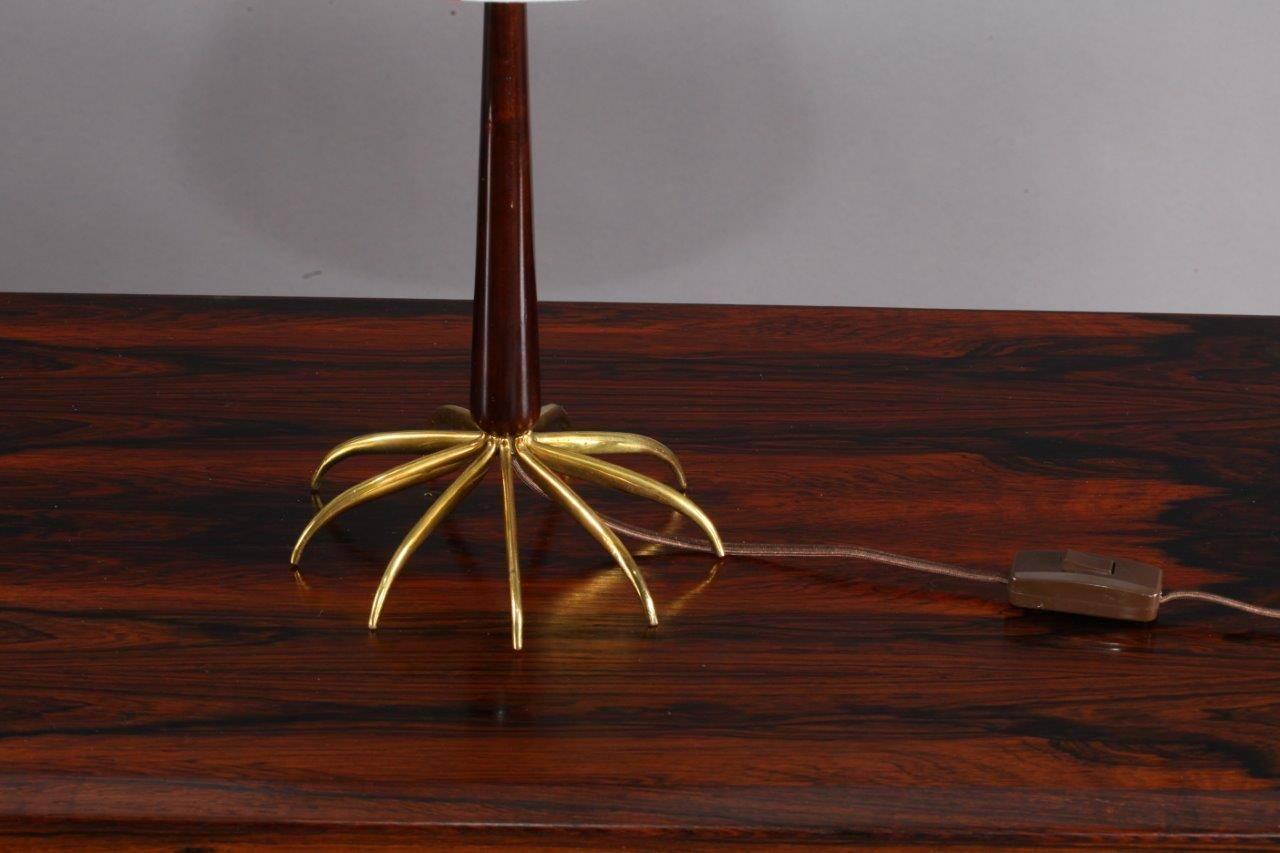 Table lamp,
Rupert Nikoll,
Vienna, 1950.
Modell Spider
brass base,
wooden teak stam,
fabric shade.