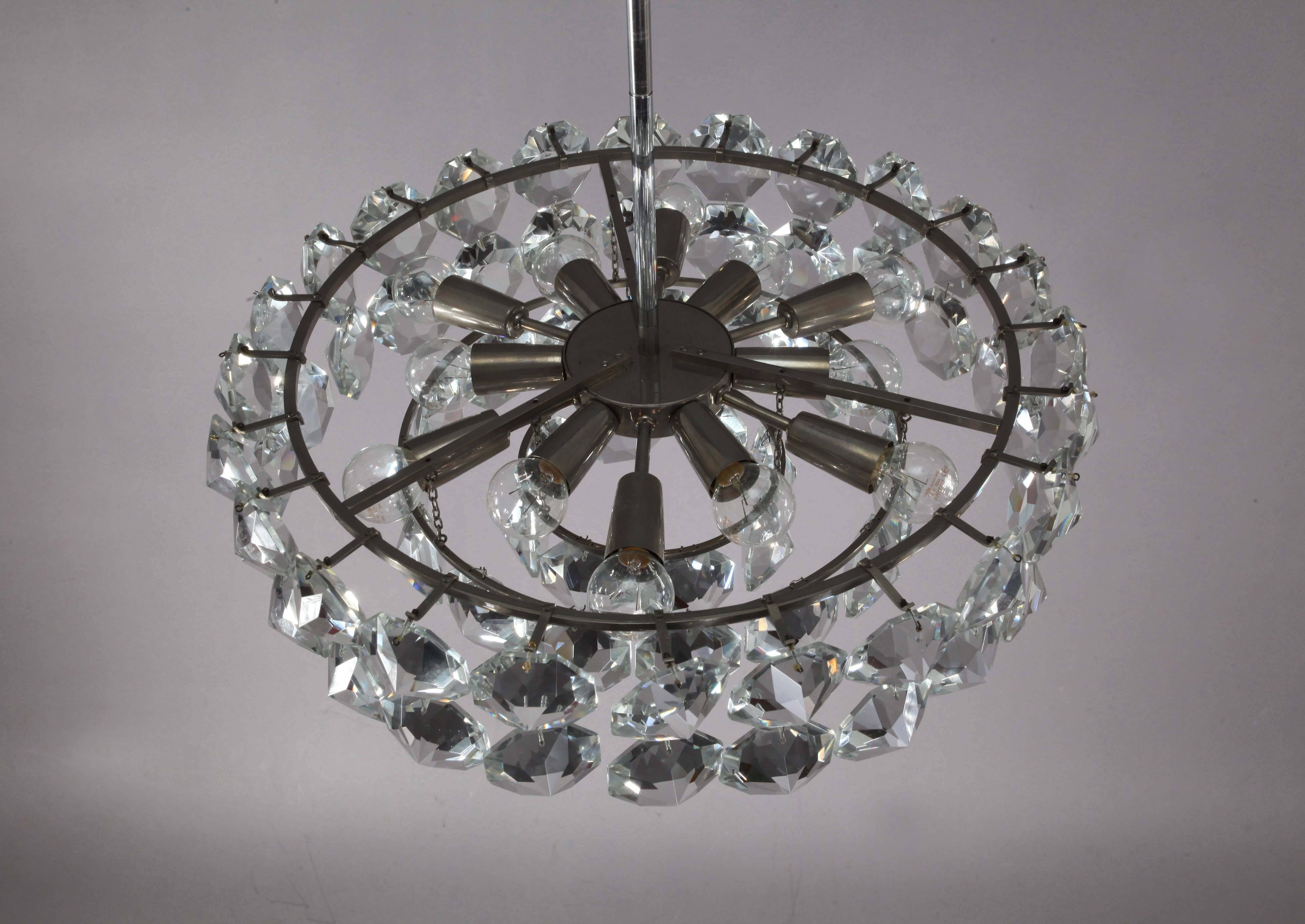 Gorgeous chandelier by Bakalowits & Sohne featuring a multitude of very uniquely sized large (each 6.5 x 6.5 cm) and exquisite with big sparkling octagon gem-like crystals hanging from a nickeled brass frame. 12 bulbs are illuminating this