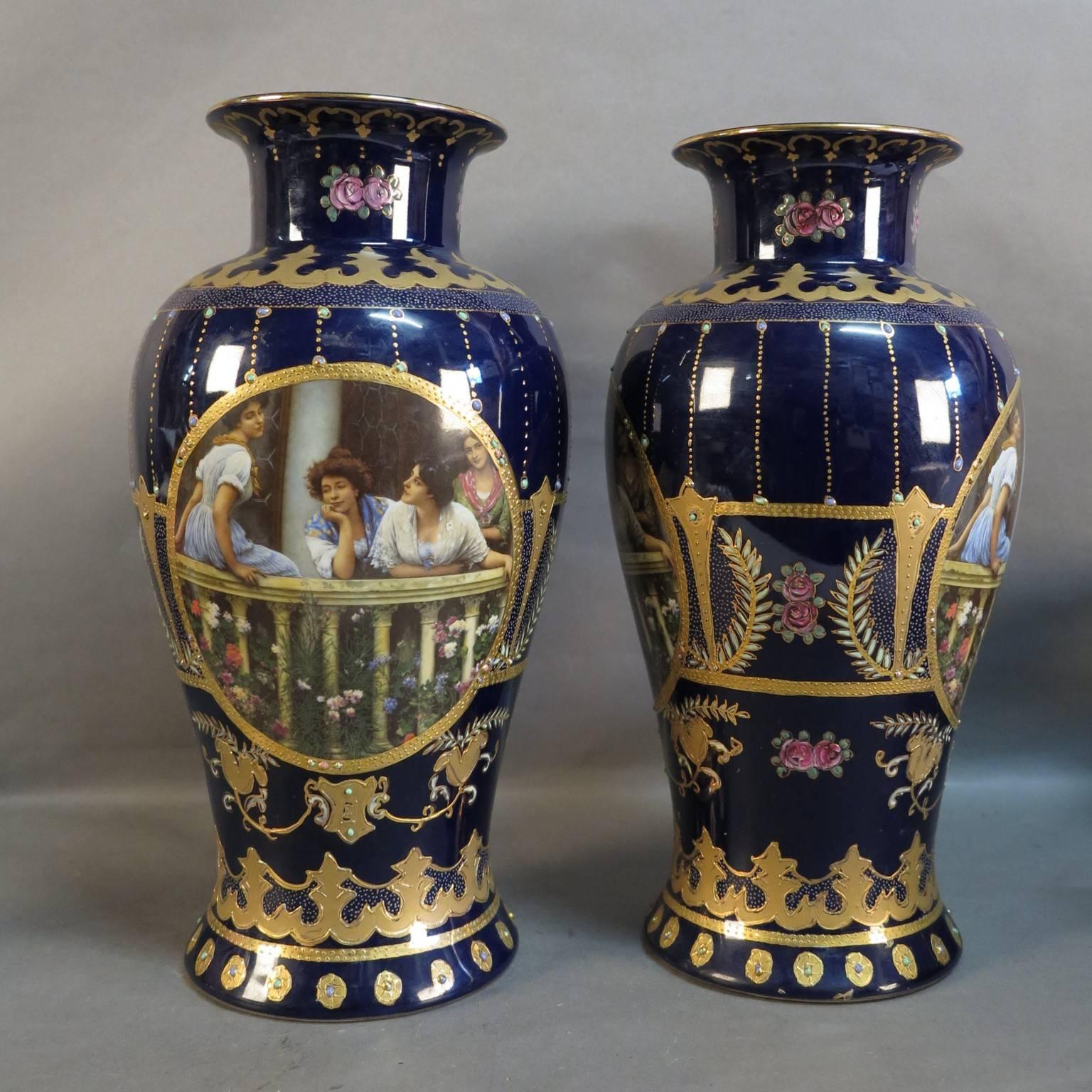 Pair of Art Nouveau pottery vases by Royal LImoges. The vases have elaborate ornaments in gold, and on the both sides the same pictures of four young ladies.
