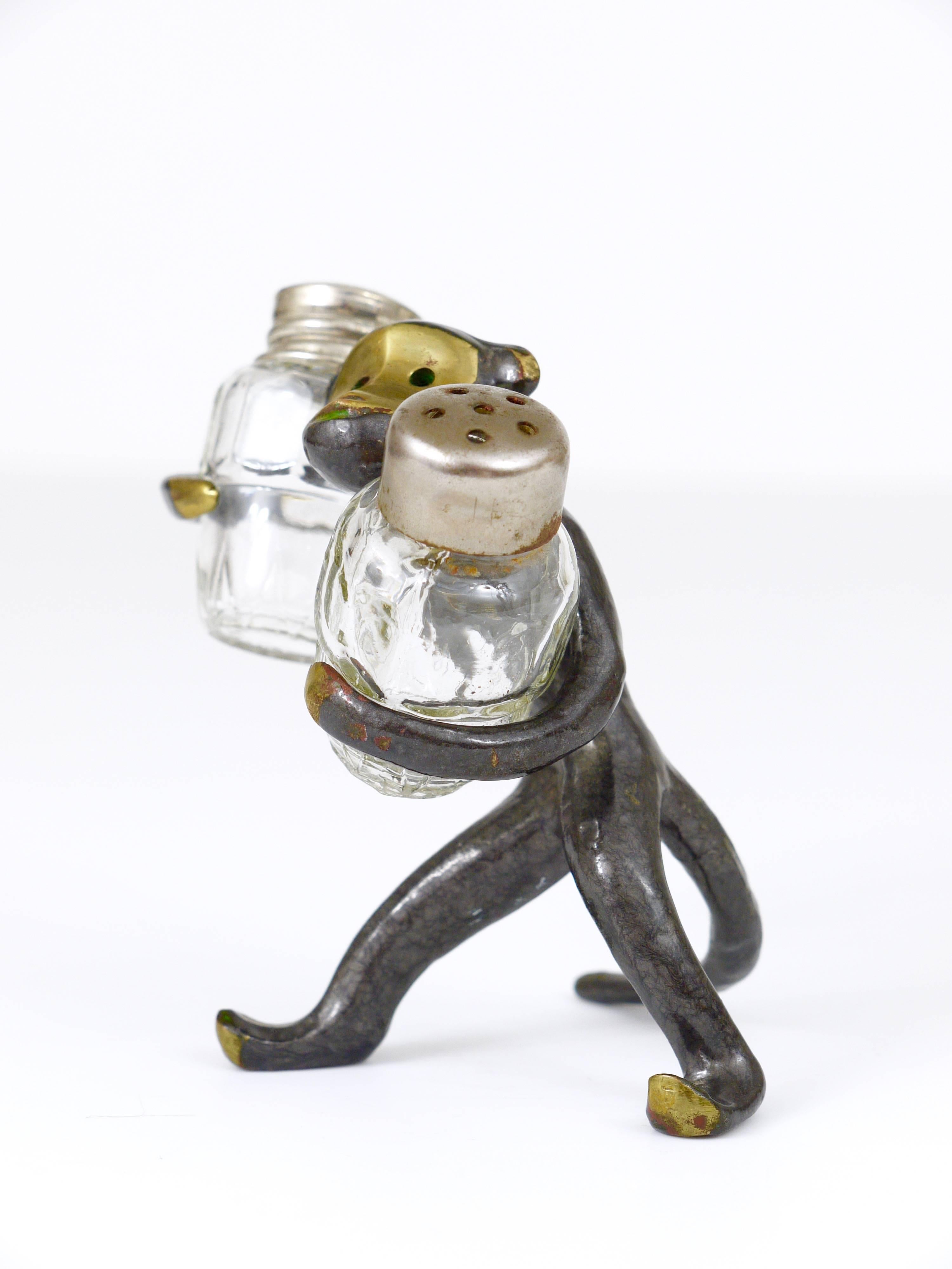 A very charming Austrian shaker set, displaying a monkey. A very humorous design by Walter Bosse, manufactured by Baller Austria in the 1950s. Made of brass, in good condition with nice patina.