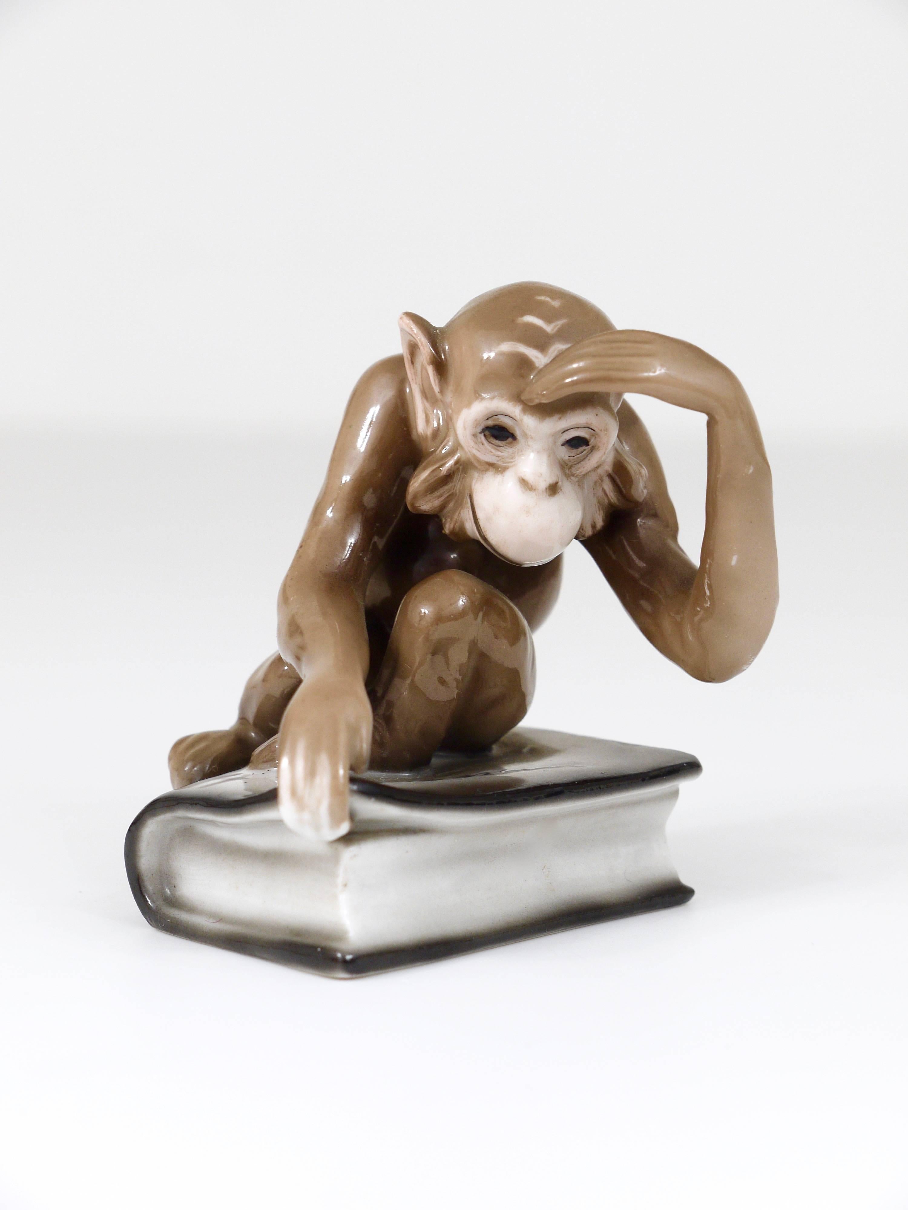 An unusual porcelain figurine displaying a monkey sitting on a book by Charles Darwin. This nice figurine was manufactured by Haas & Czjzek, Schlaggenwald, Bohemia in the 1940s. In excellent condition. 
