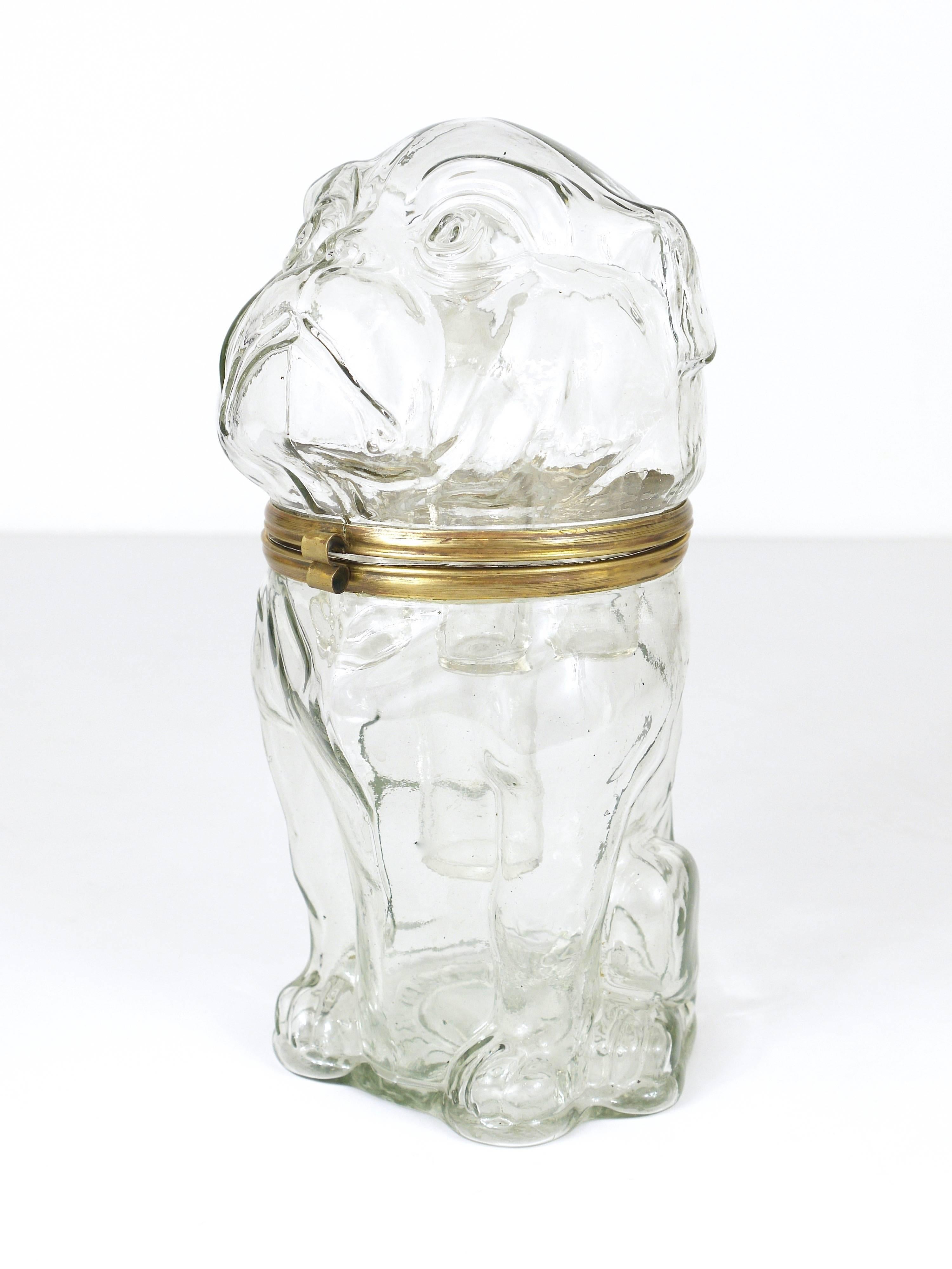 An extraordinary decanter bar set, made of glass, in the shape of a sitting bulldog. Made in the 1920s in Czechoslovakia. Has an integrated bottle and six glasses, the dog can also be used as an ice bucket. A very outstanding and unusual piece. 
