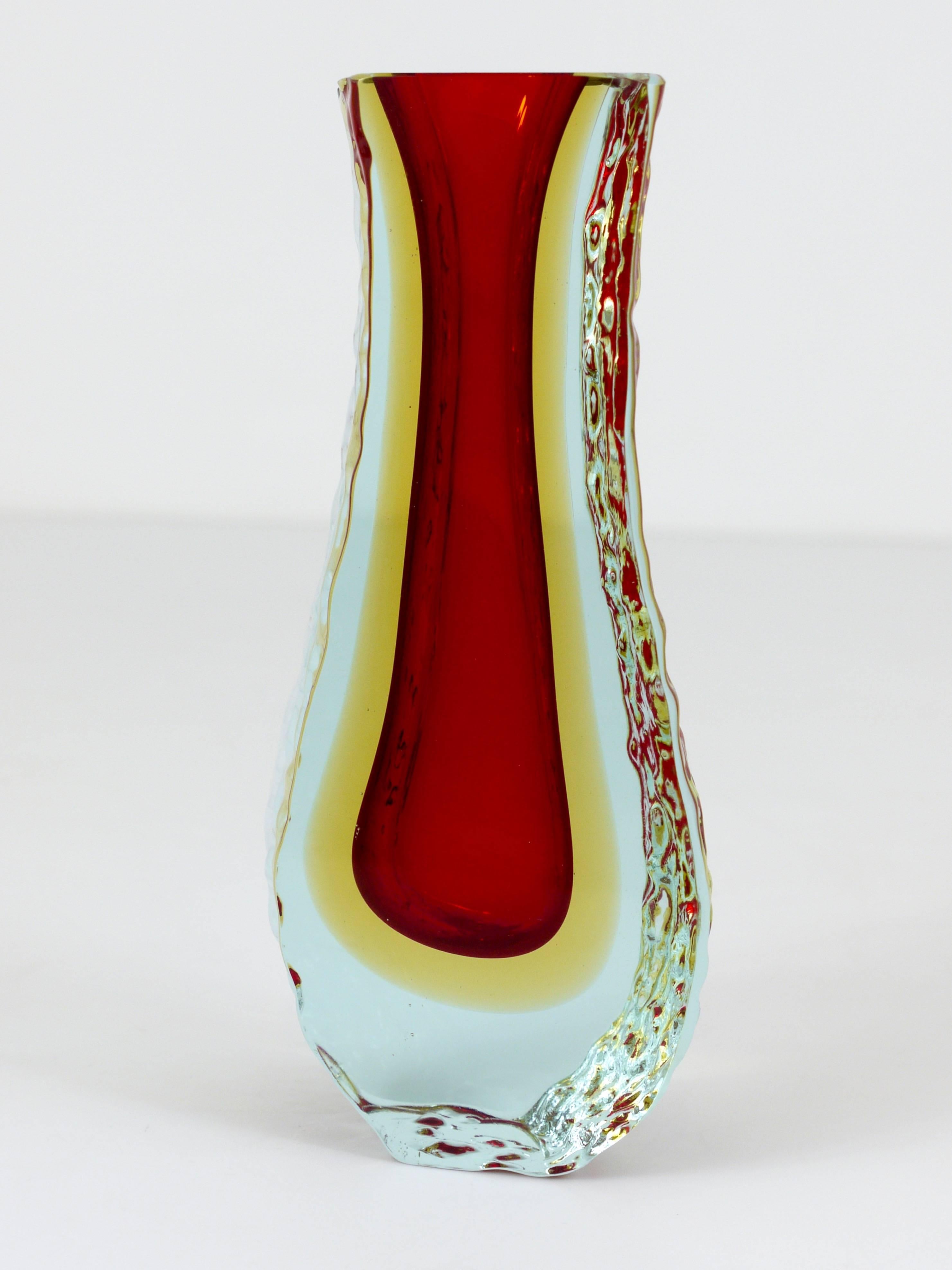 An Italian Sommerso glass vase, executed by Mandruzzato in the 1960s in Murano. It has a wonderful shape with polished front and back and textured sides.  A beautiful combination of three colours, red, yellow, yellow and light blue glass. In