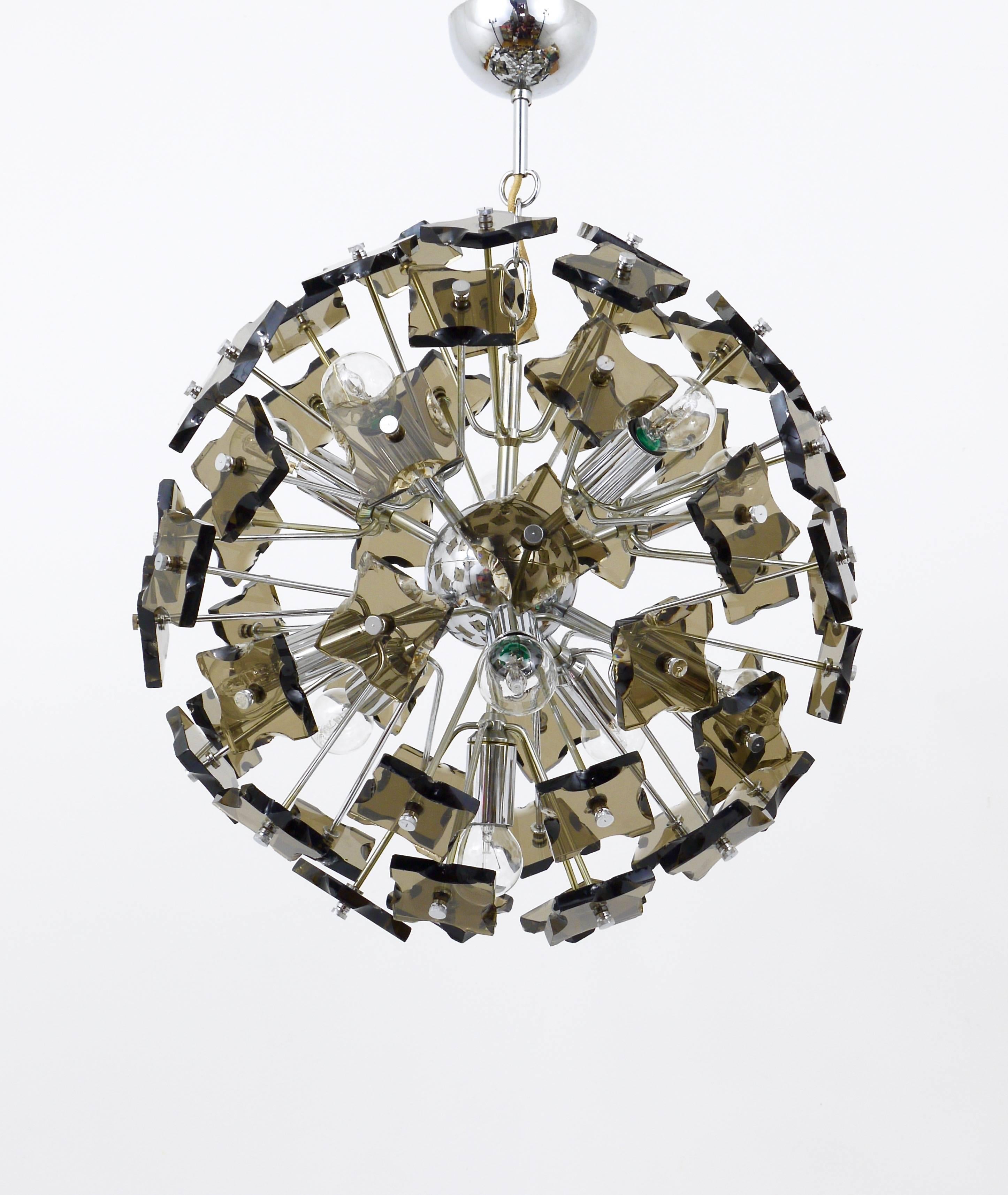 A beautiful and impressive Italian Sputnik chandelier vintage pendant light from the 1960s. 60 thick and solid hand-chipped smoked cut glass elements on a chrome-plated hardware. 11 light sources, 19 inches diameter. In very good condition. In the