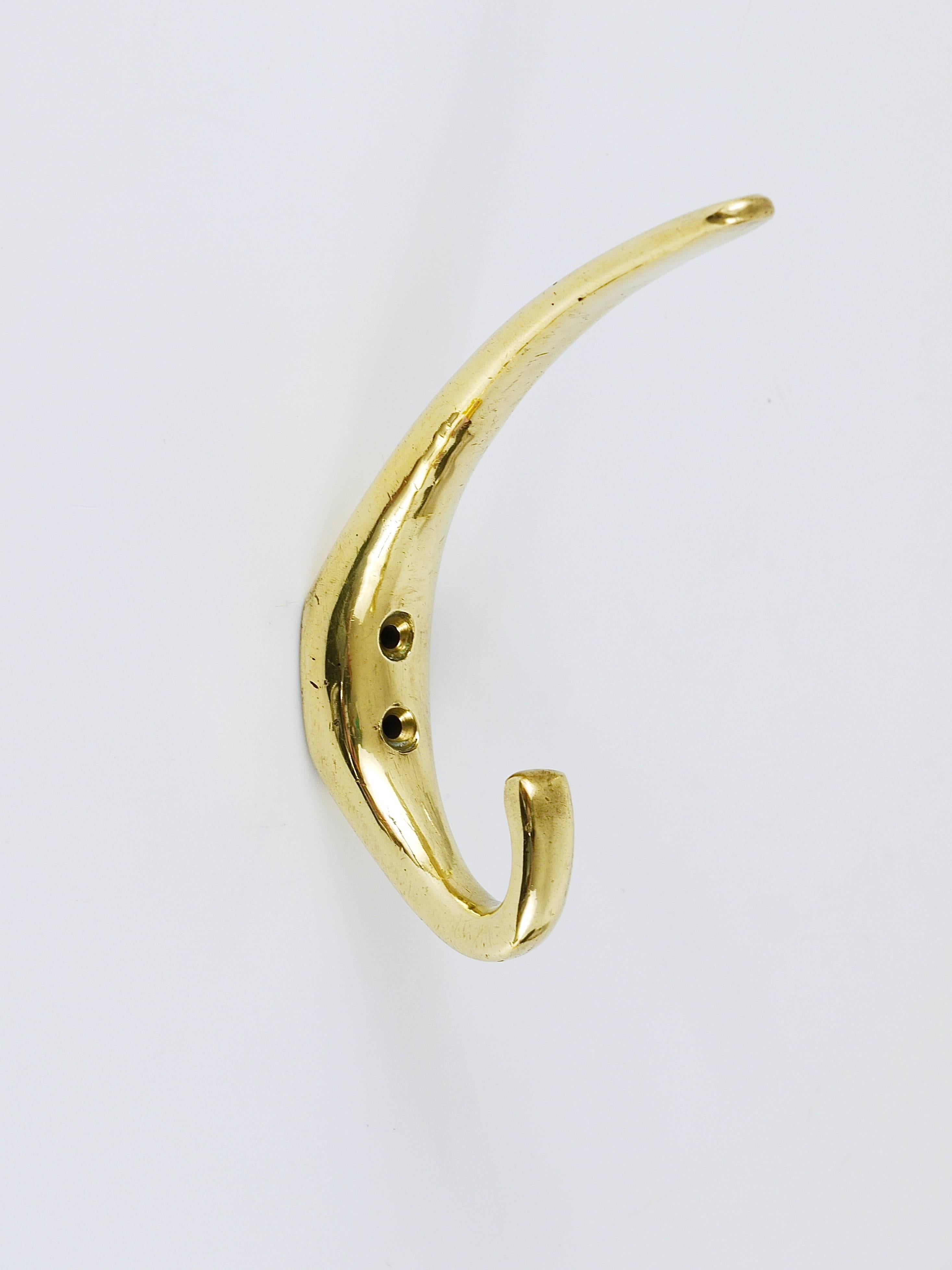 Five beautiful brass wall hooks, handcrafted in the 1950s, Vienna, Austria. Gently polished by hand, in very good condition with nice patina. Sold per piece.